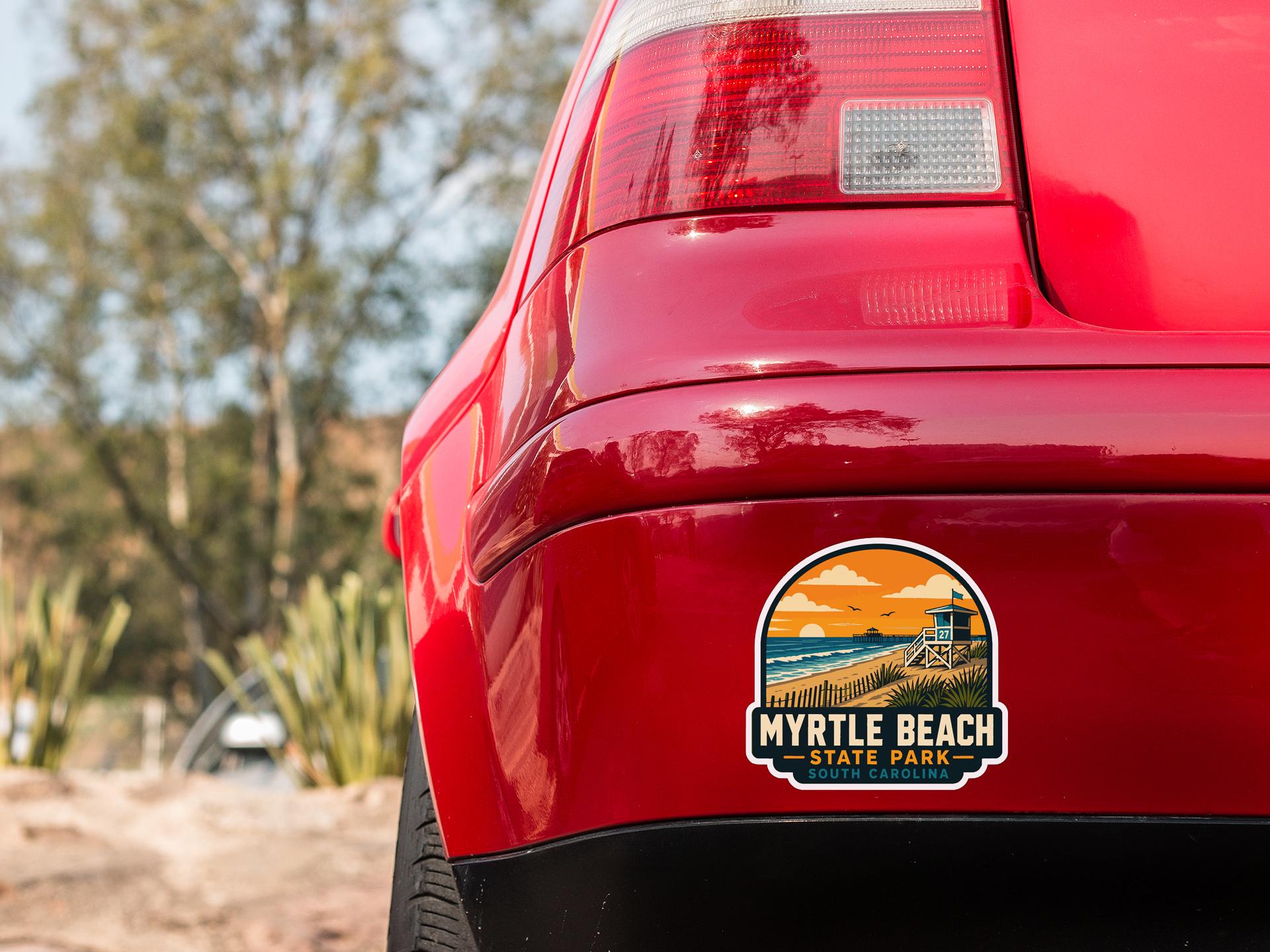 the rear end of a red car with a sticker on the back window that says "Myrtle Beach State Park".