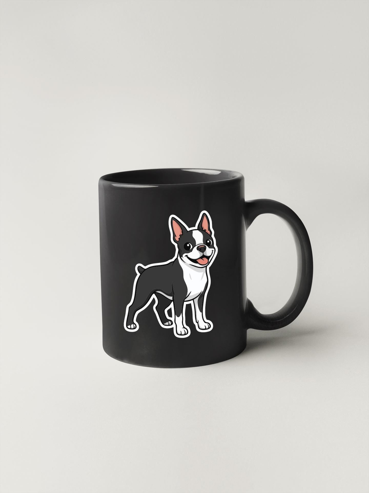 A black coffee mug with a cartoon illustration of a Boston Terrier dog on it.