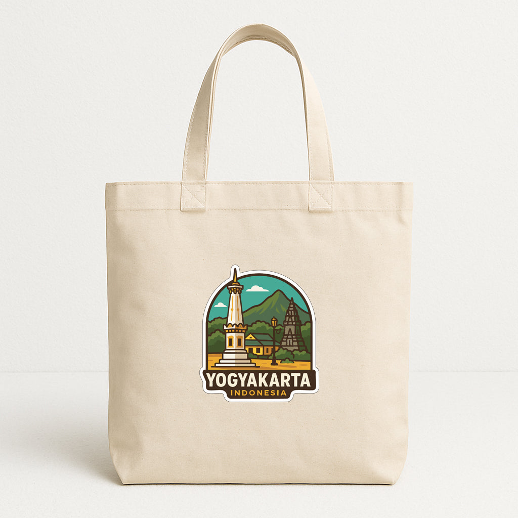 A beige tote bag with a graphic design featuring a temple and mountains, along with the text "YOGYAKARTA INDONESIA".