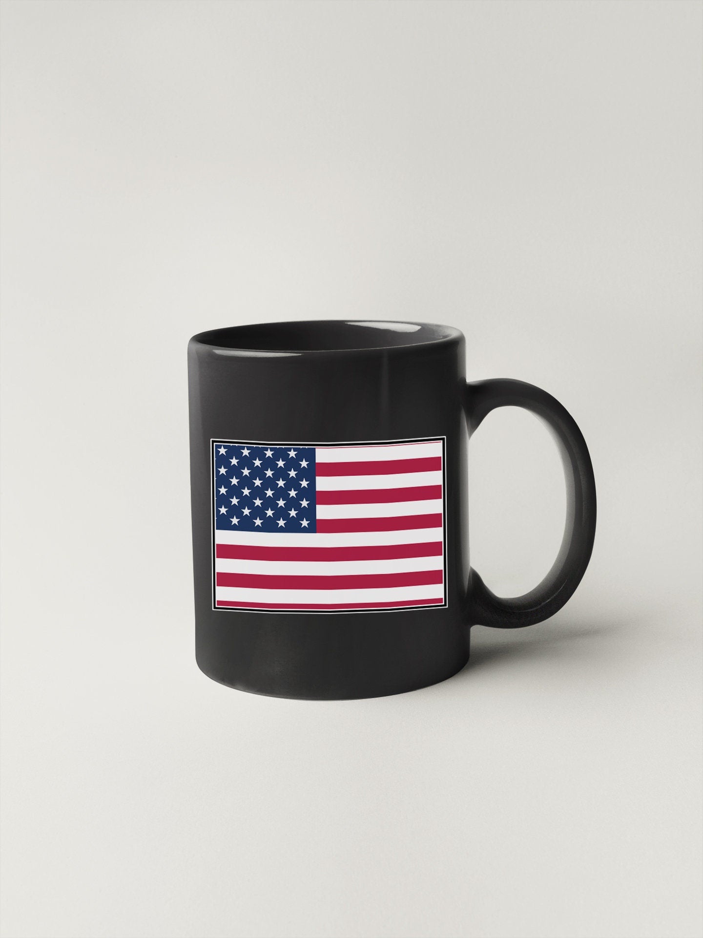 a black coffee mug with the american flag on it