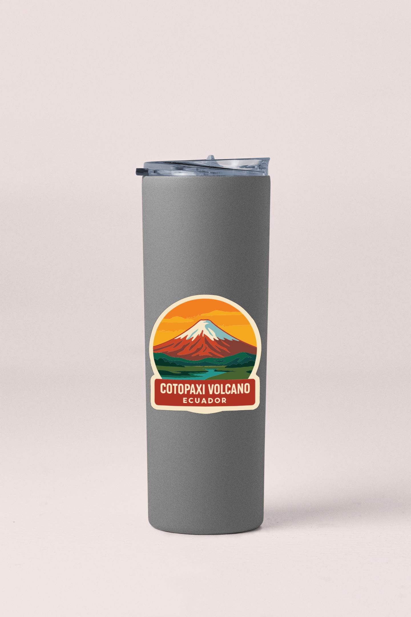 A gray tumbler with a sticker depicting a mountain and the text "COTOPAXI VOLCANO ECUADOR".