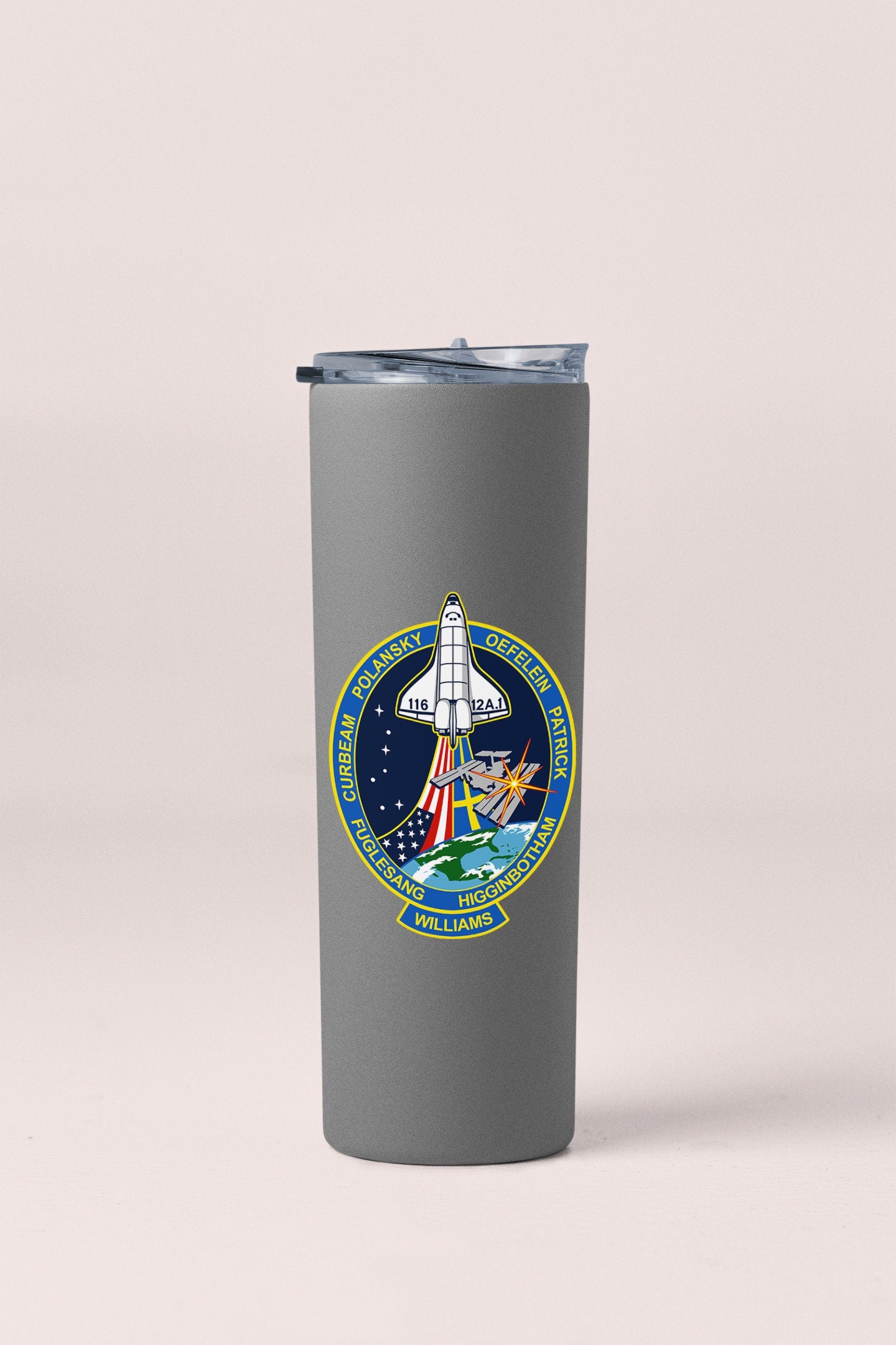 a stainless steel tumbler with a nasa emblem on it