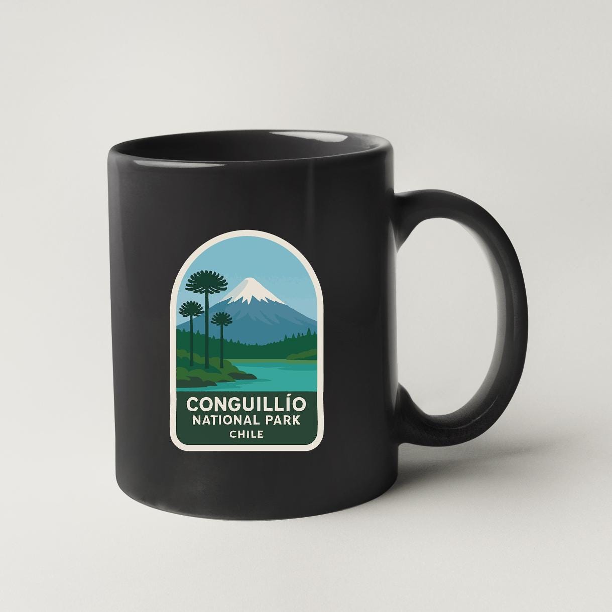 A black coffee mug with a label that says "CONGUILLO NATIONAL PARK CHILE".