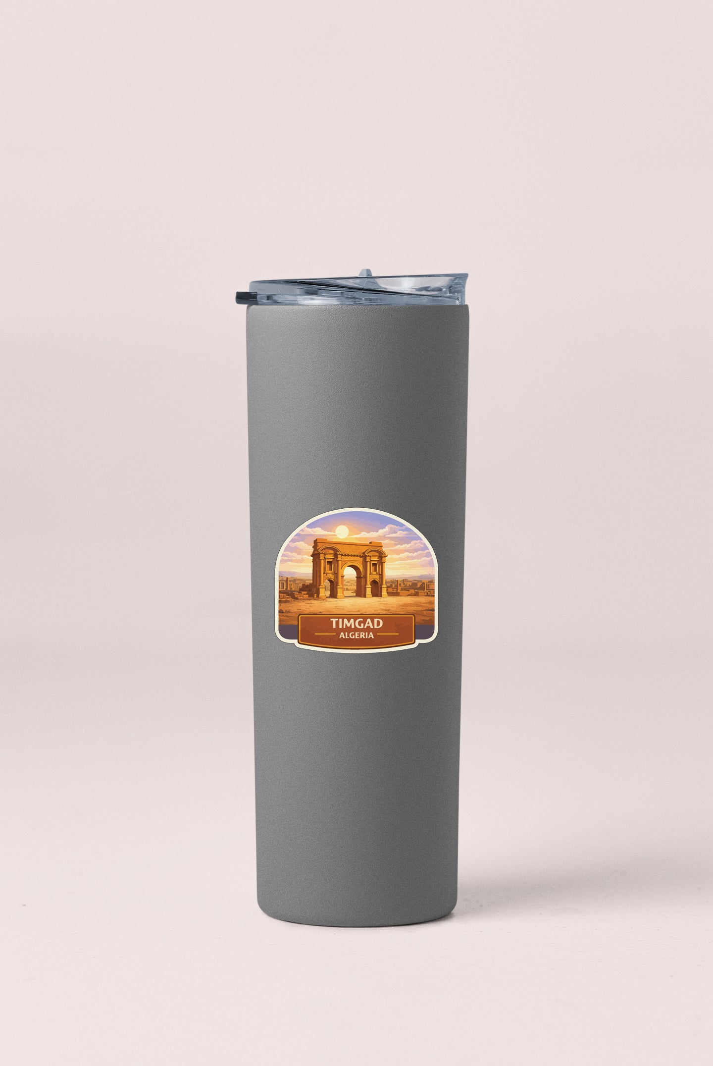 A gray insulated tumbler with a lid and a label that says "Timgad, Algeria".