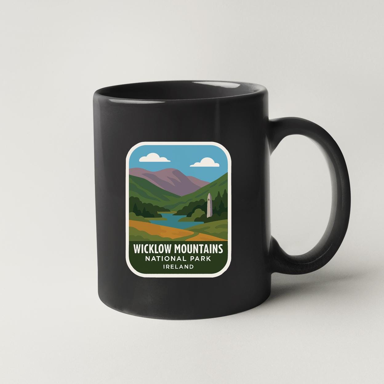 A black coffee mug with a label that says "Wicklow Mountains National Park, Ireland".