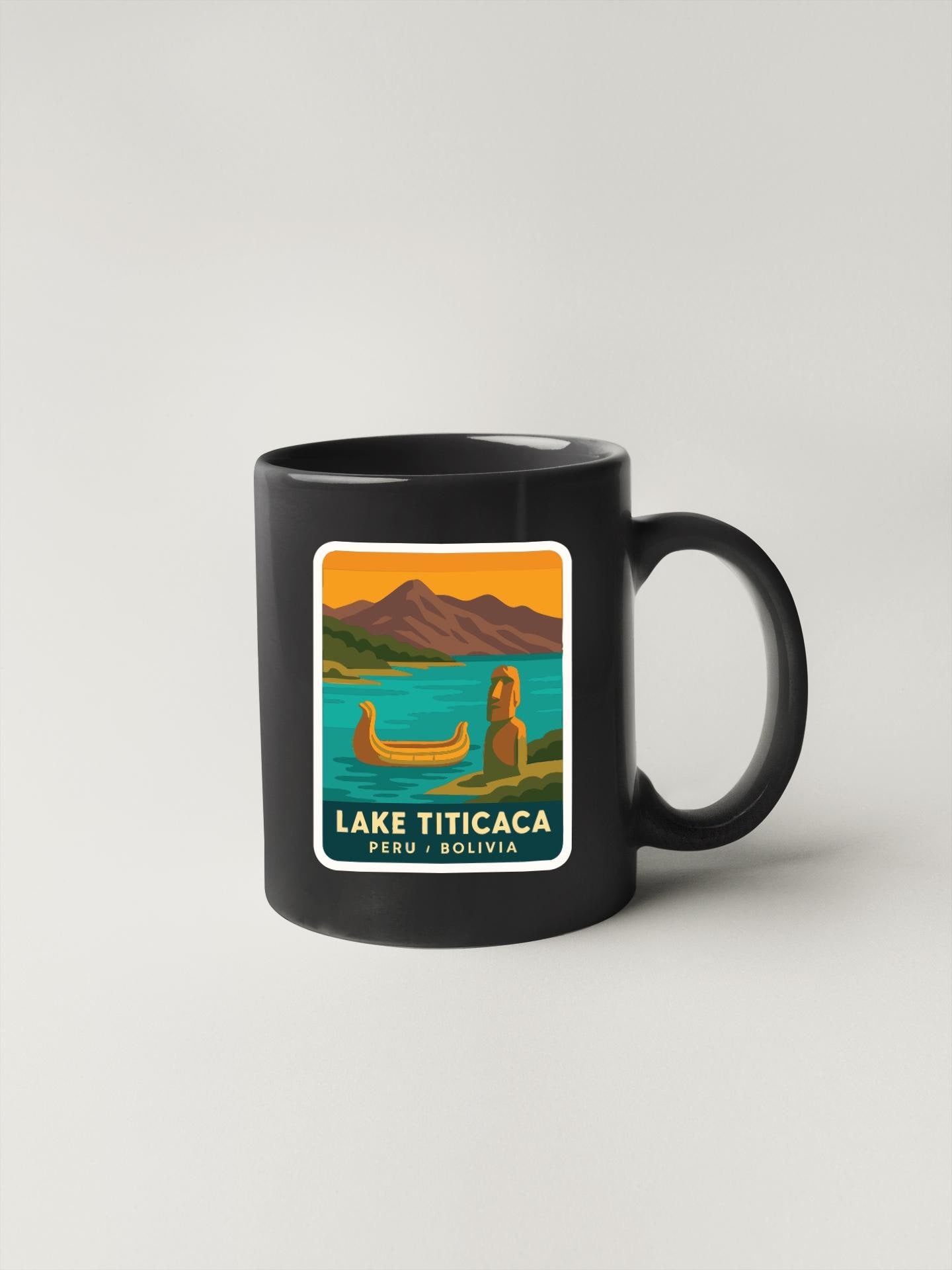 A black coffee mug with a colorful illustration of Lake Titicaca, a famous landmark in Peru, featuring a canoe and mountains in the background.