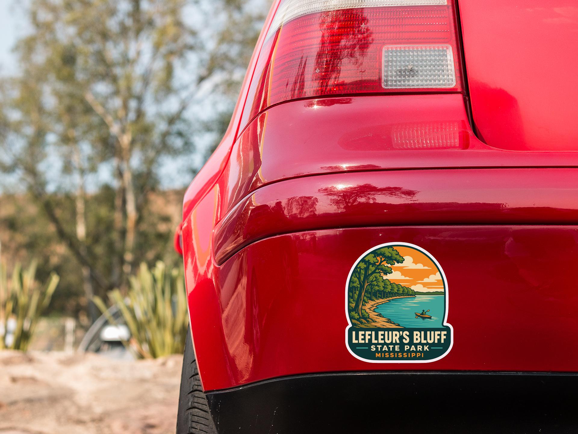 the rear end of a red car with a sticker on the bumper that says "LEFLEUR'S BLUFF STATE PARK MISSISSIPPI".