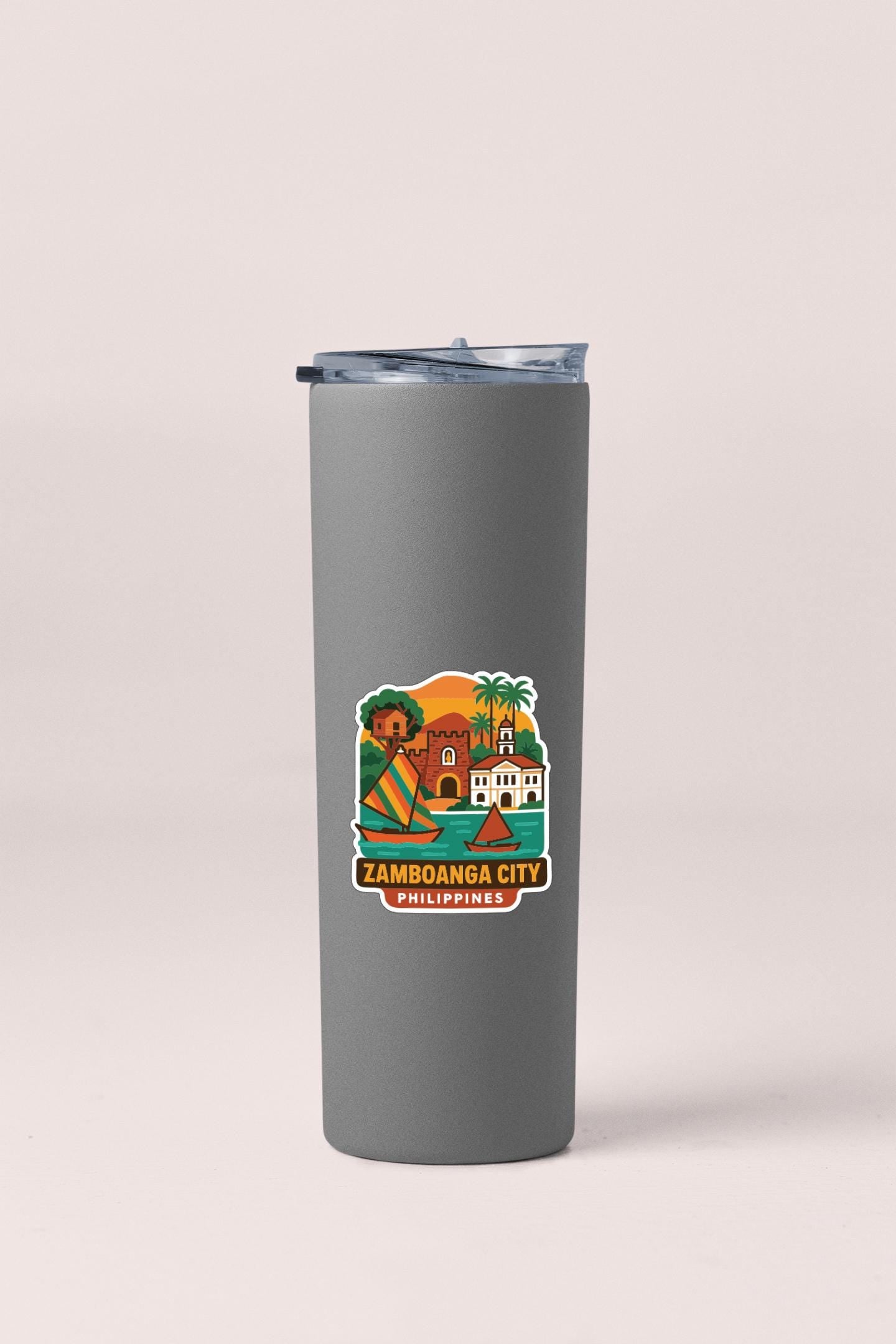 A gray insulated tumbler with a sticker depicting a tropical city scene, specifically Zamboanga City, Philippines.
