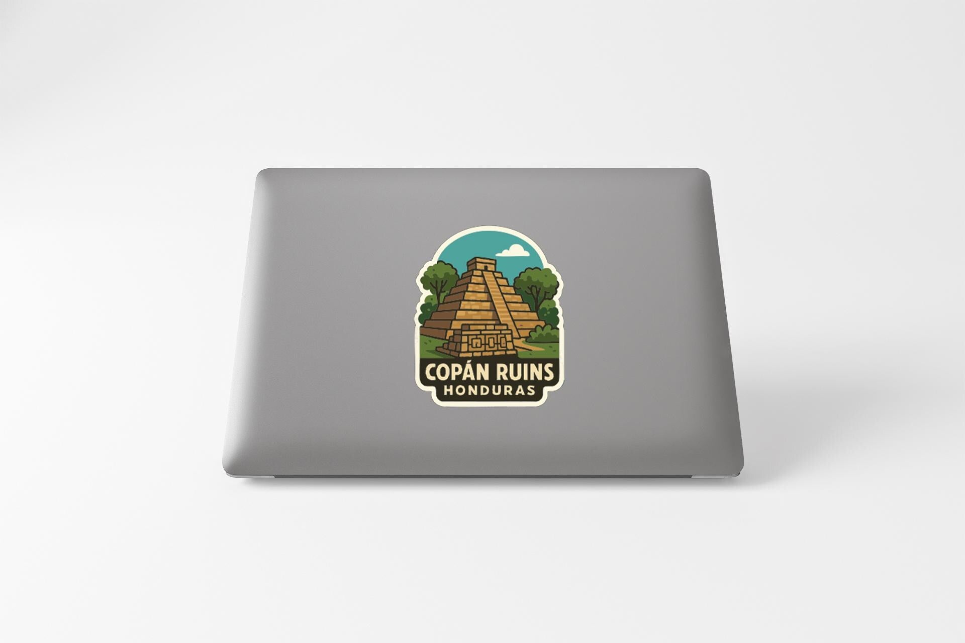 a sticker with a graphic of a pyramid and the text "COPAN RUINS HONDURAS" on a laptop.