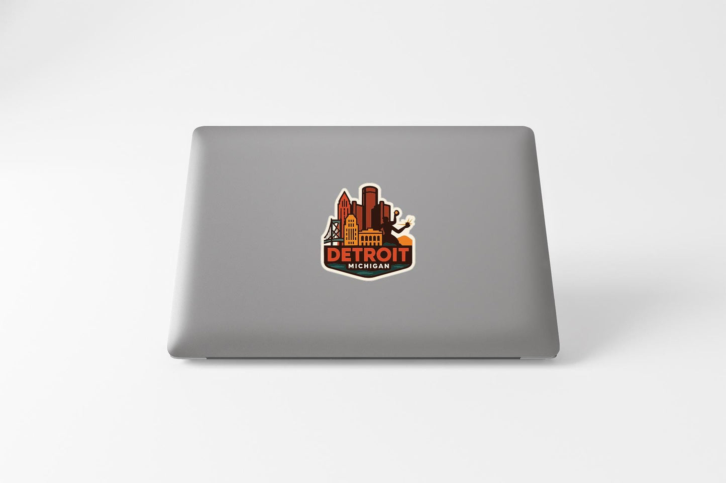 A sticker featuring the city of Detroit, Michigan, with various landmarks and buildings depicted in a stylized manner.