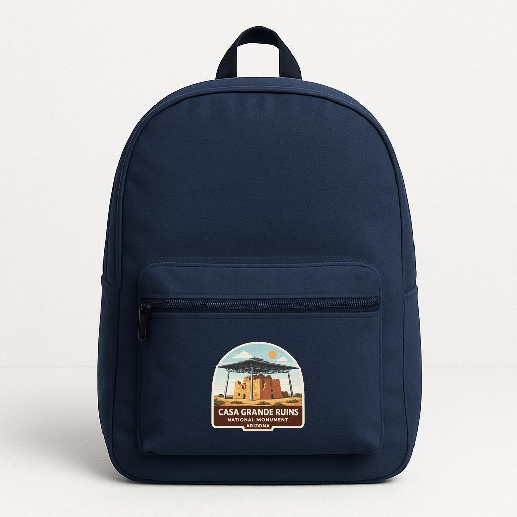A navy blue backpack with a label that says "CASA GRANDE RUINS ARIZONA" on the front pocket area.