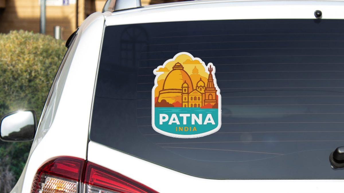 a sticker on the rear window of a car that says "PATNA INDIA".