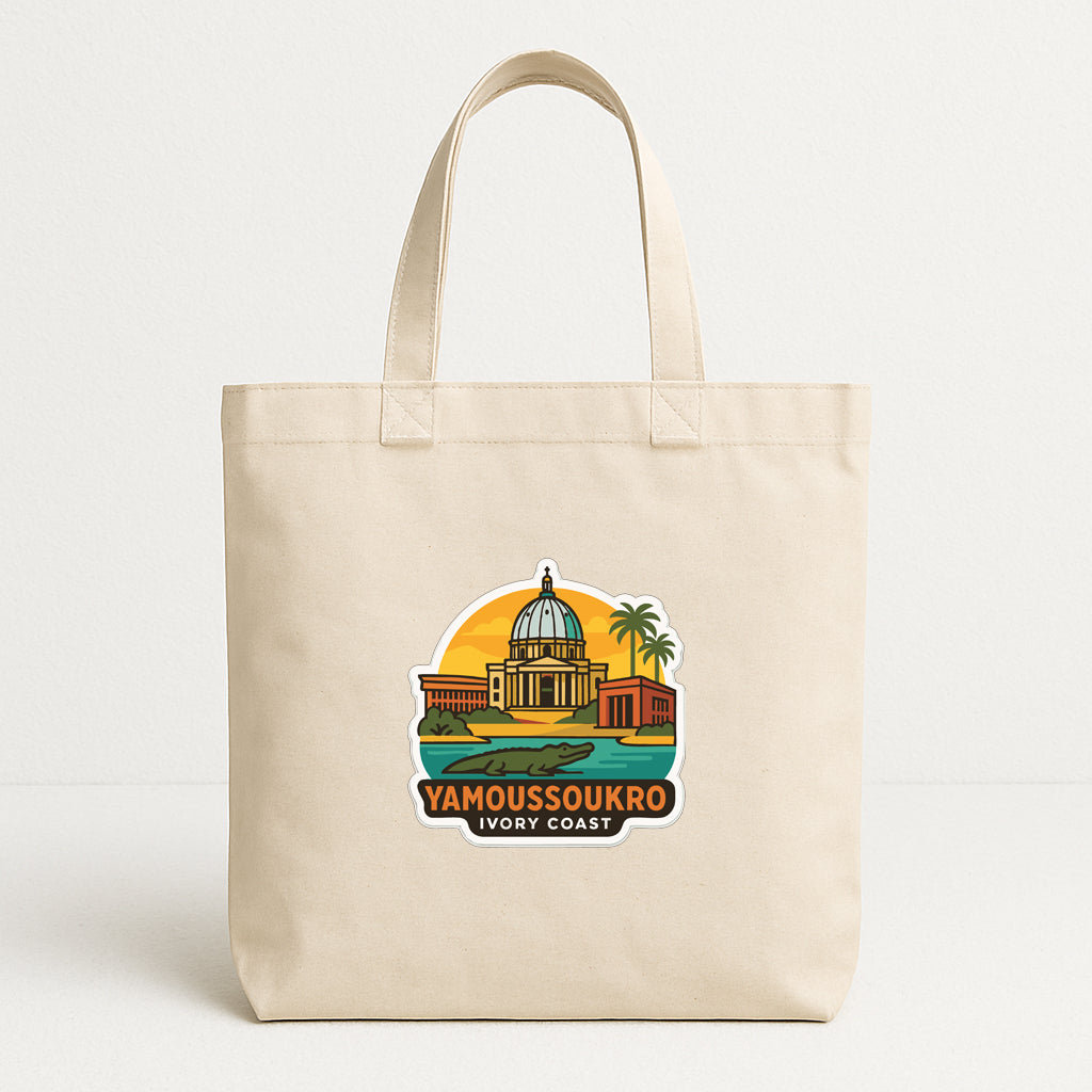 A beige tote bag with a graphic design depicting a landmark, specifically the Yamboussoukro Ivory Coast, printed on it.