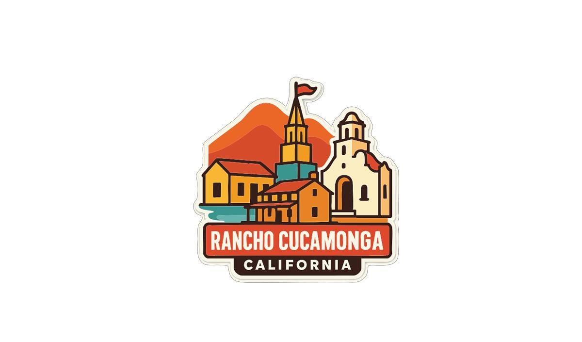 a colorful sticker or emblem with a stylized illustration of a town or city, including buildings, mountains, and a flag.