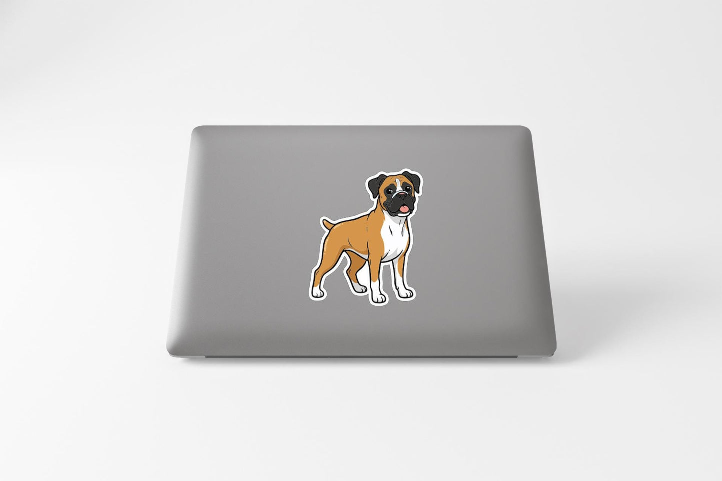 A sticker of a cartoon dog is on the back of a laptop.