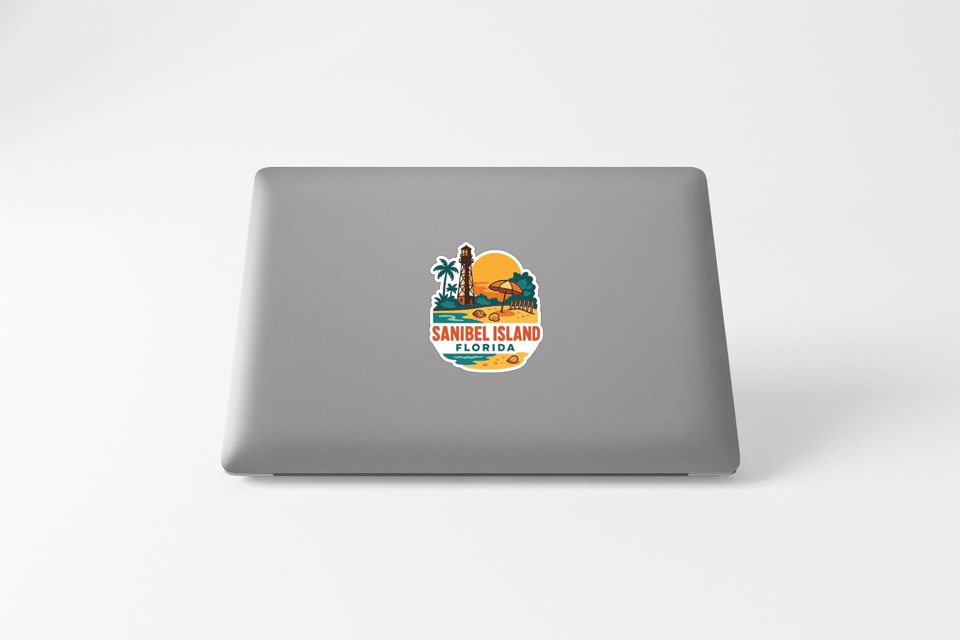 a sticker with a tropical island design on the back of a laptop.
