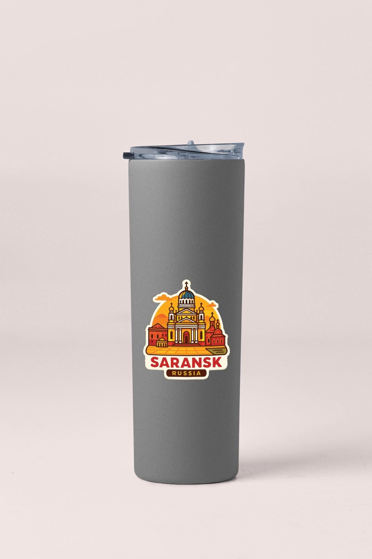 A gray insulated tumbler with a graphic design featuring a city skyline and the text "SARANSK RUSSIA" printed on it.