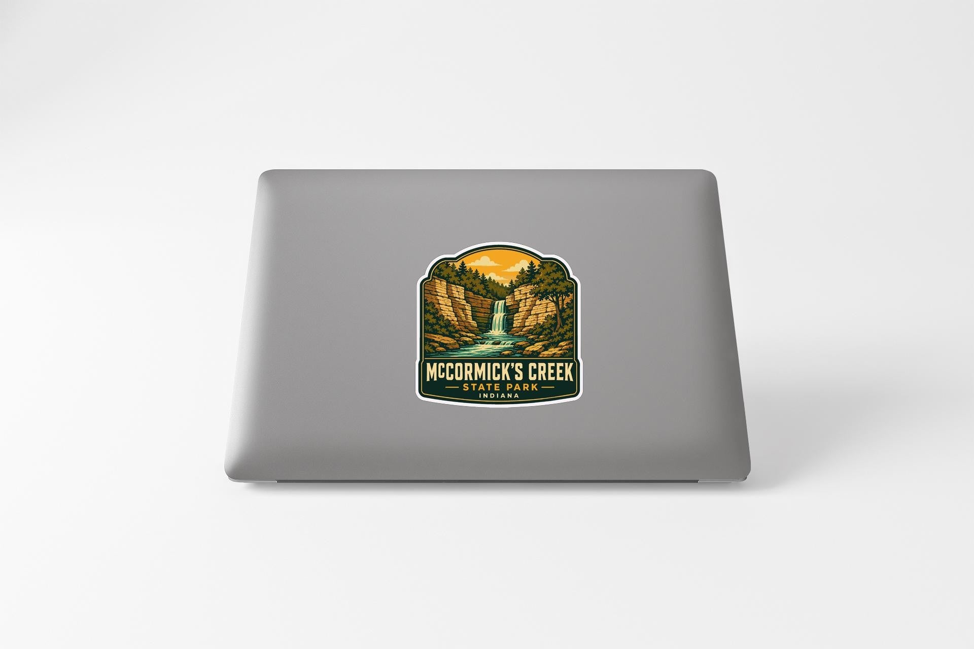 a sticker with a scenic landscape of a waterfall and mountains, along with the text "Mc Cormick's Creek" and "Yellow Park".