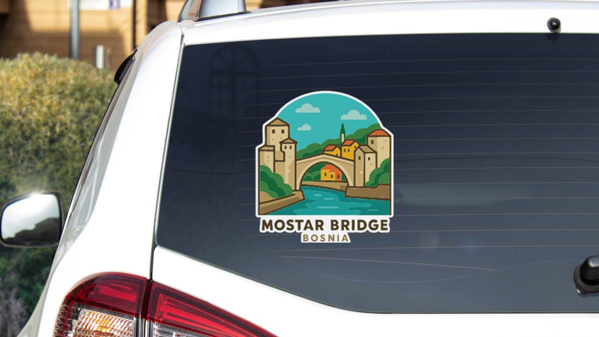 Sticker on rear window of a white car with a picture of the Mostar Bridge in Bosnia and Herzegovina.