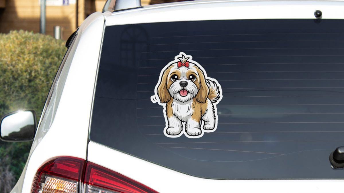 a sticker of a dog on the rear window of a car.