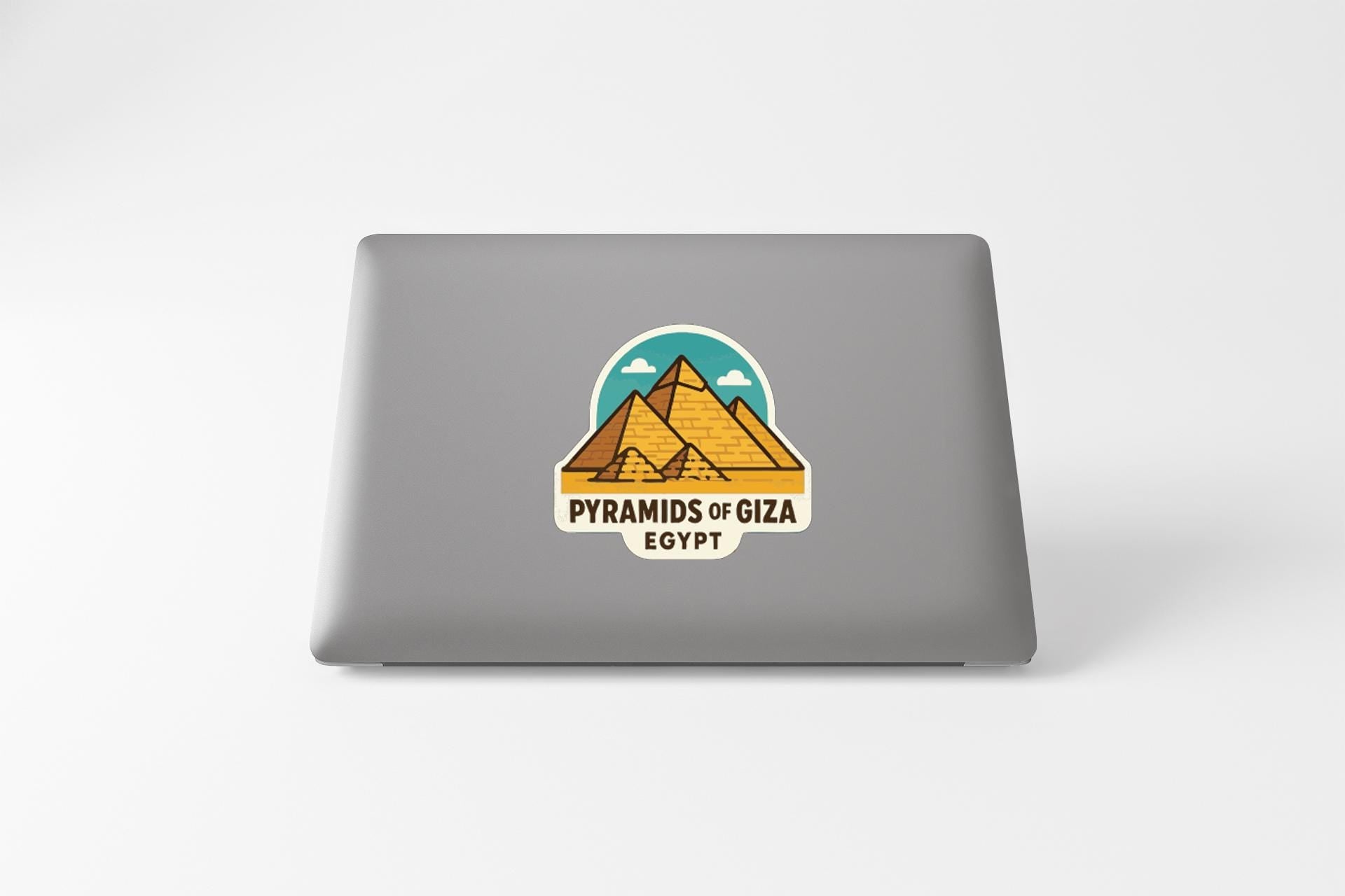 a sticker or decal on the back of a laptop, depicting the pyramids of Giza in Egypt.