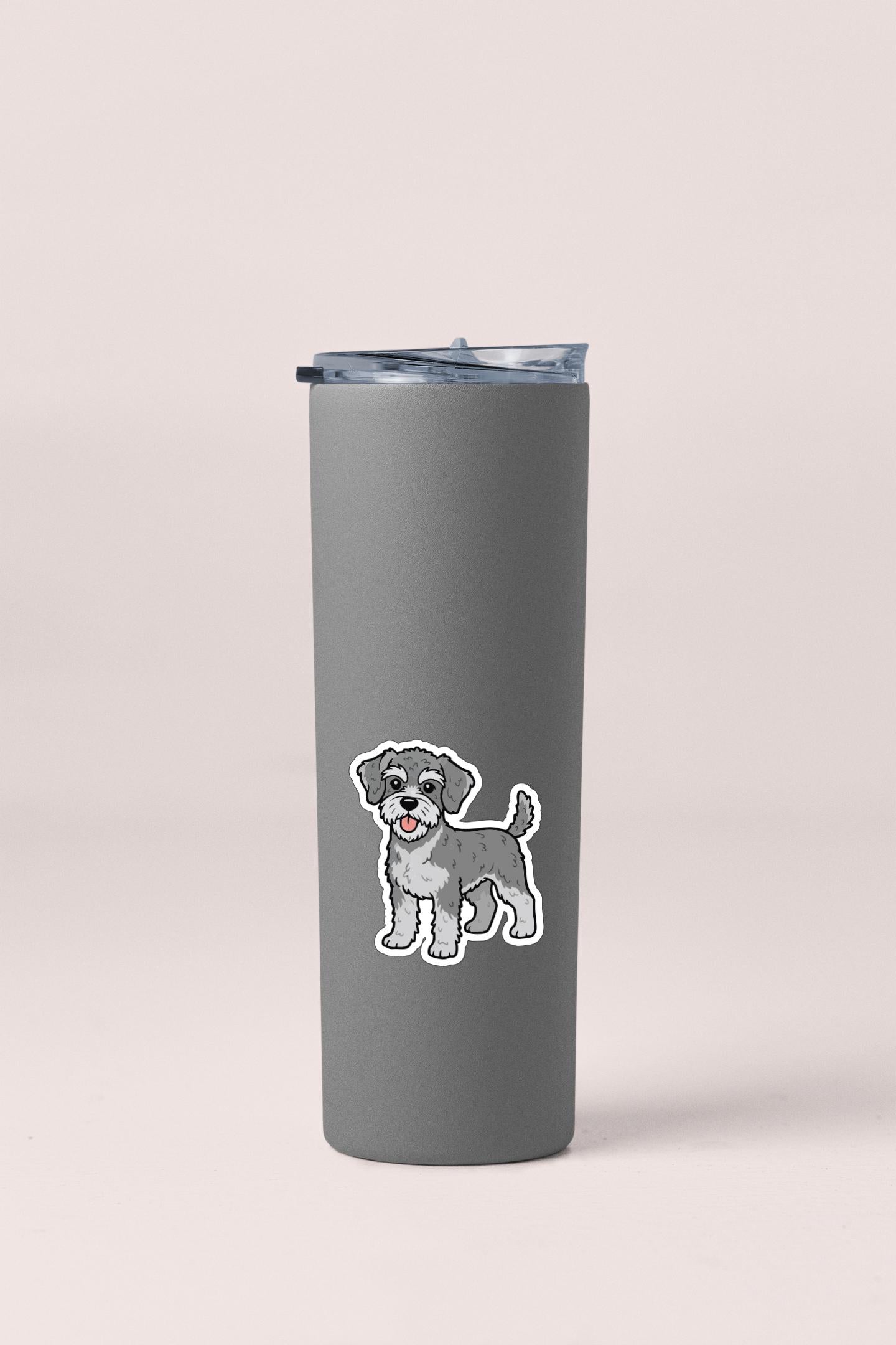 A gray insulated tumbler with a small cartoon dog sticker on it.