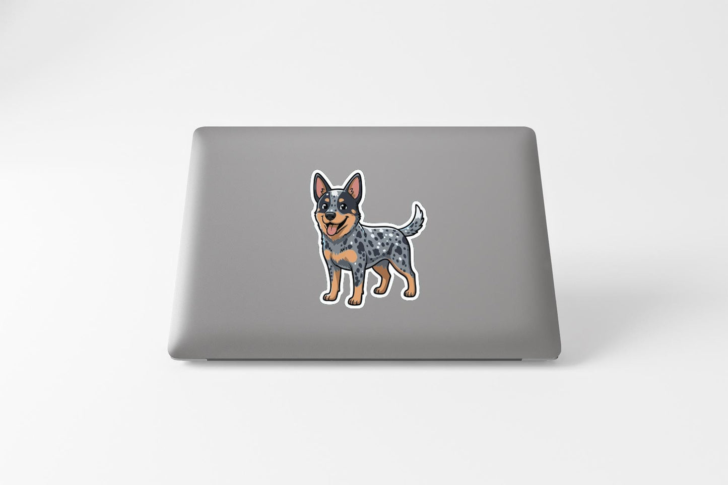 A sticker of a dog on the back of a laptop computer.
