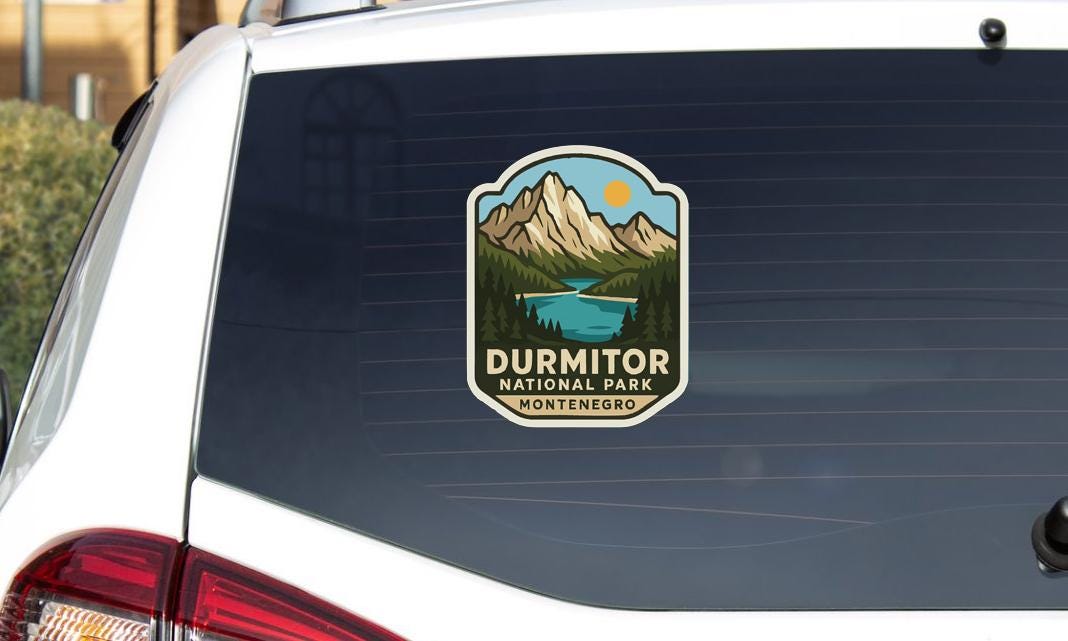 a sticker on the rear window of a car that says "DURMITOR NATIONAL PARK MONTENEGRO".