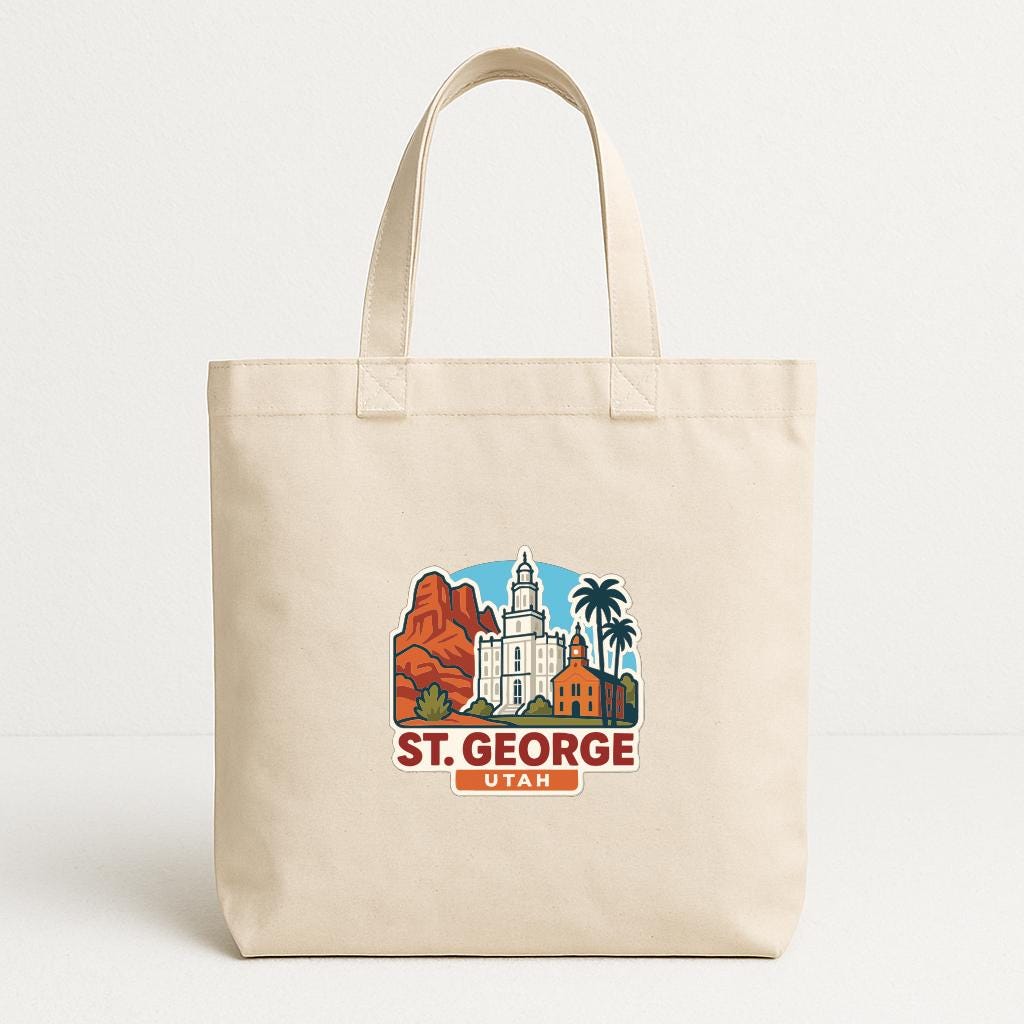 A beige tote bag with a graphic design featuring a city skyline and the text "St. George, Utah".