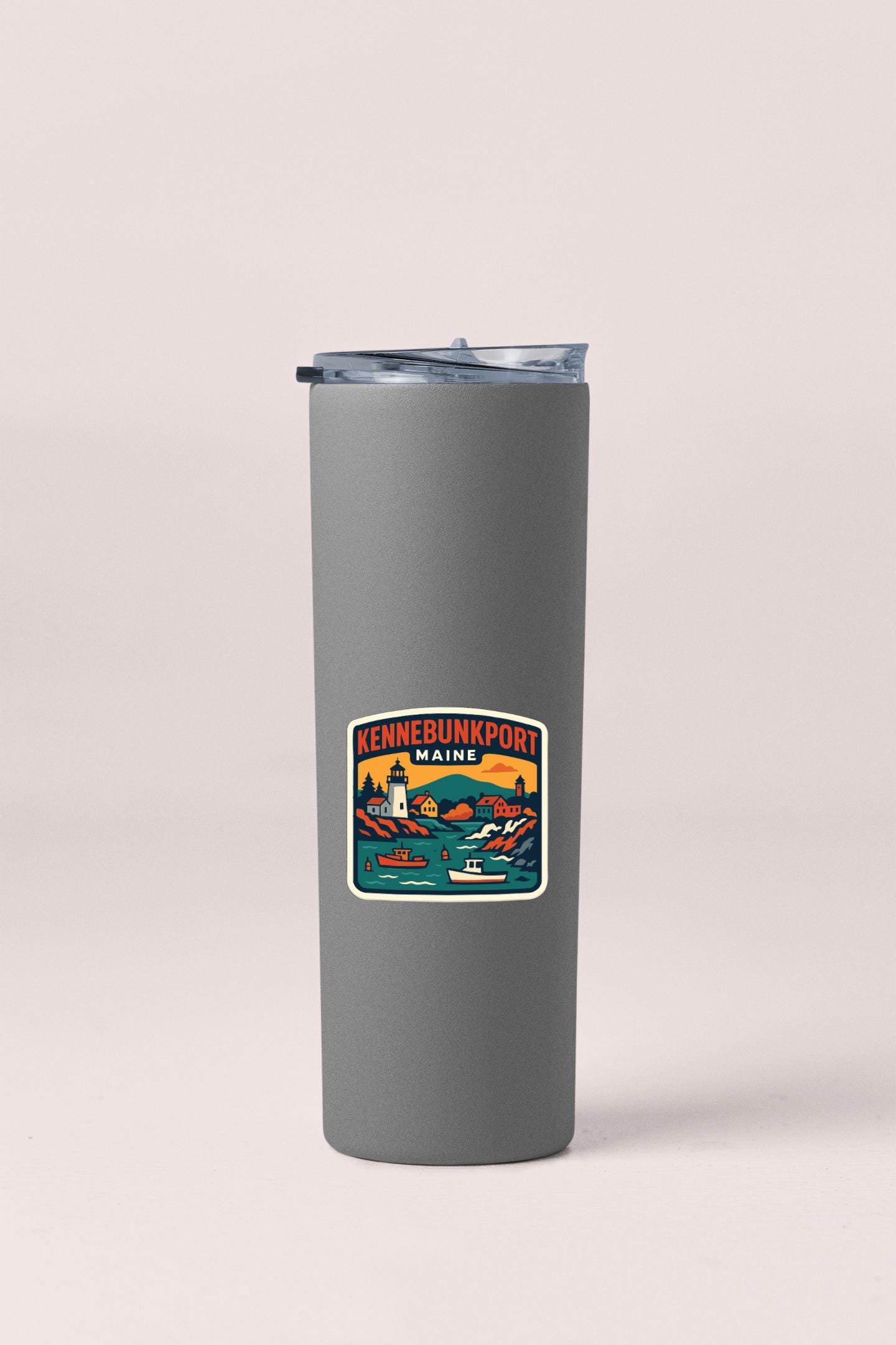 A gray insulated tumbler with a sticker depicting the Kennebunkport, Maine, area.