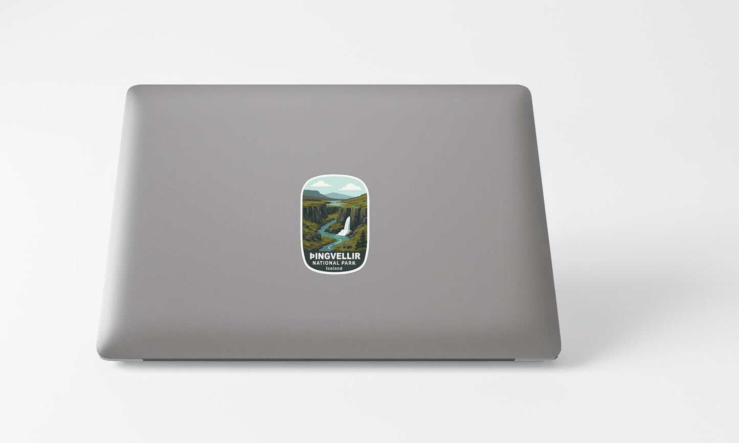 A sticker with a scenic landscape on a laptop.