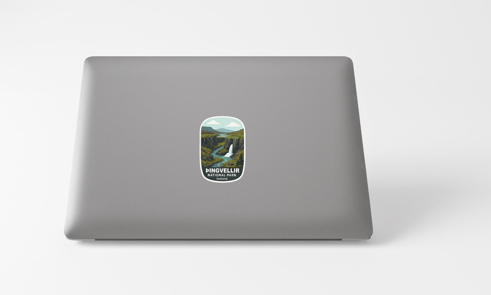 A sticker with a scenic landscape on a laptop.