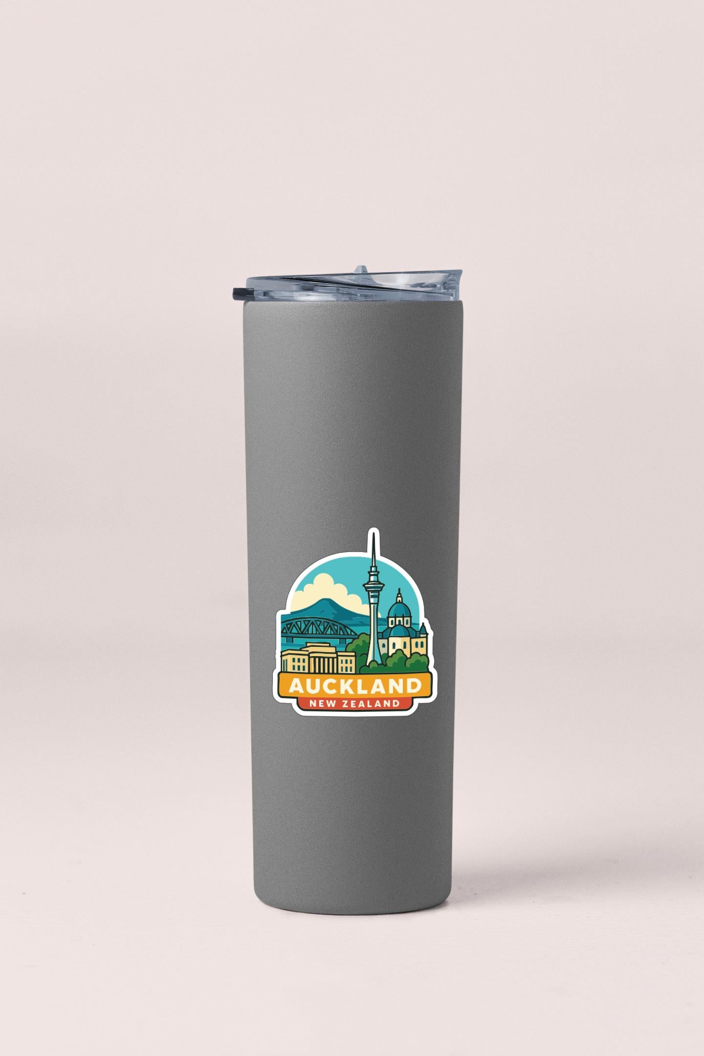 A gray insulated tumbler with a label that says "Auckland New Zealand" on it.