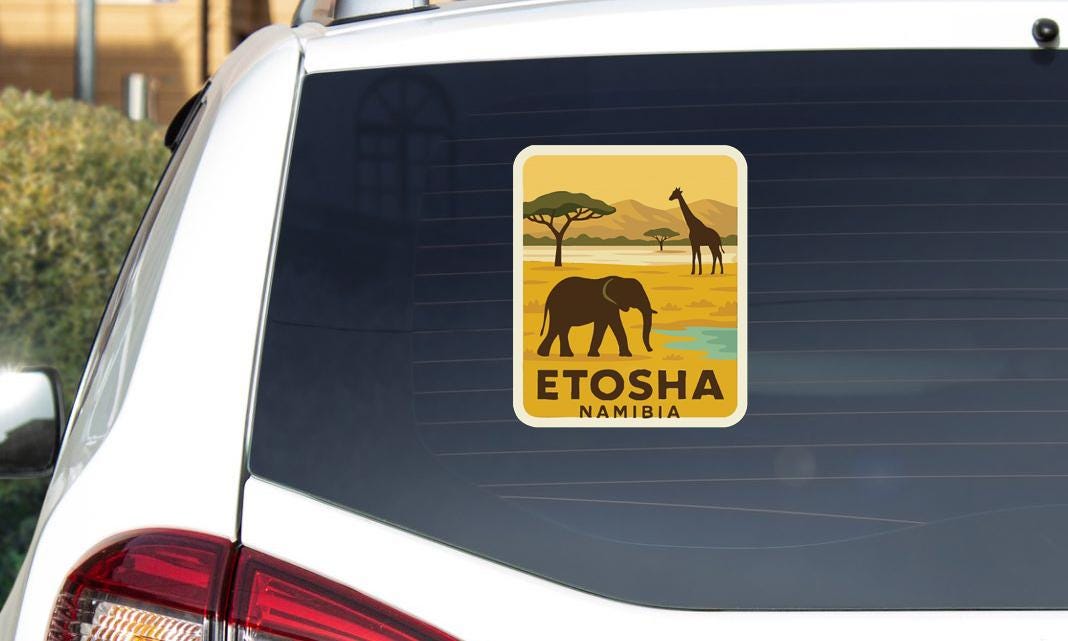 A sticker on the rear window of a car, depicting an elephant and giraffe in a savanna landscape with mountains in the background.