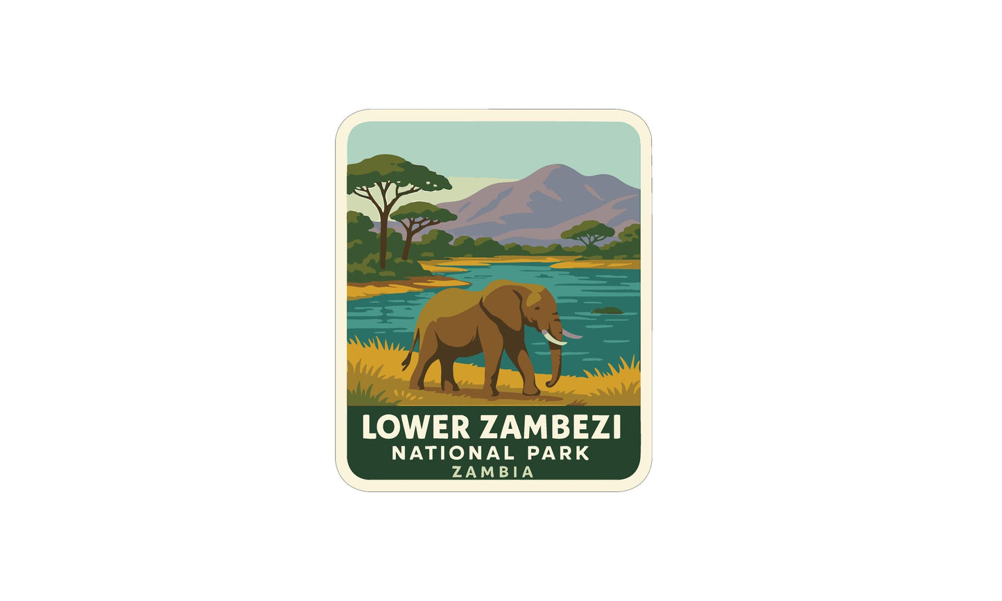 an elephant walking in a grassy area near a body of water, with mountains in the background.