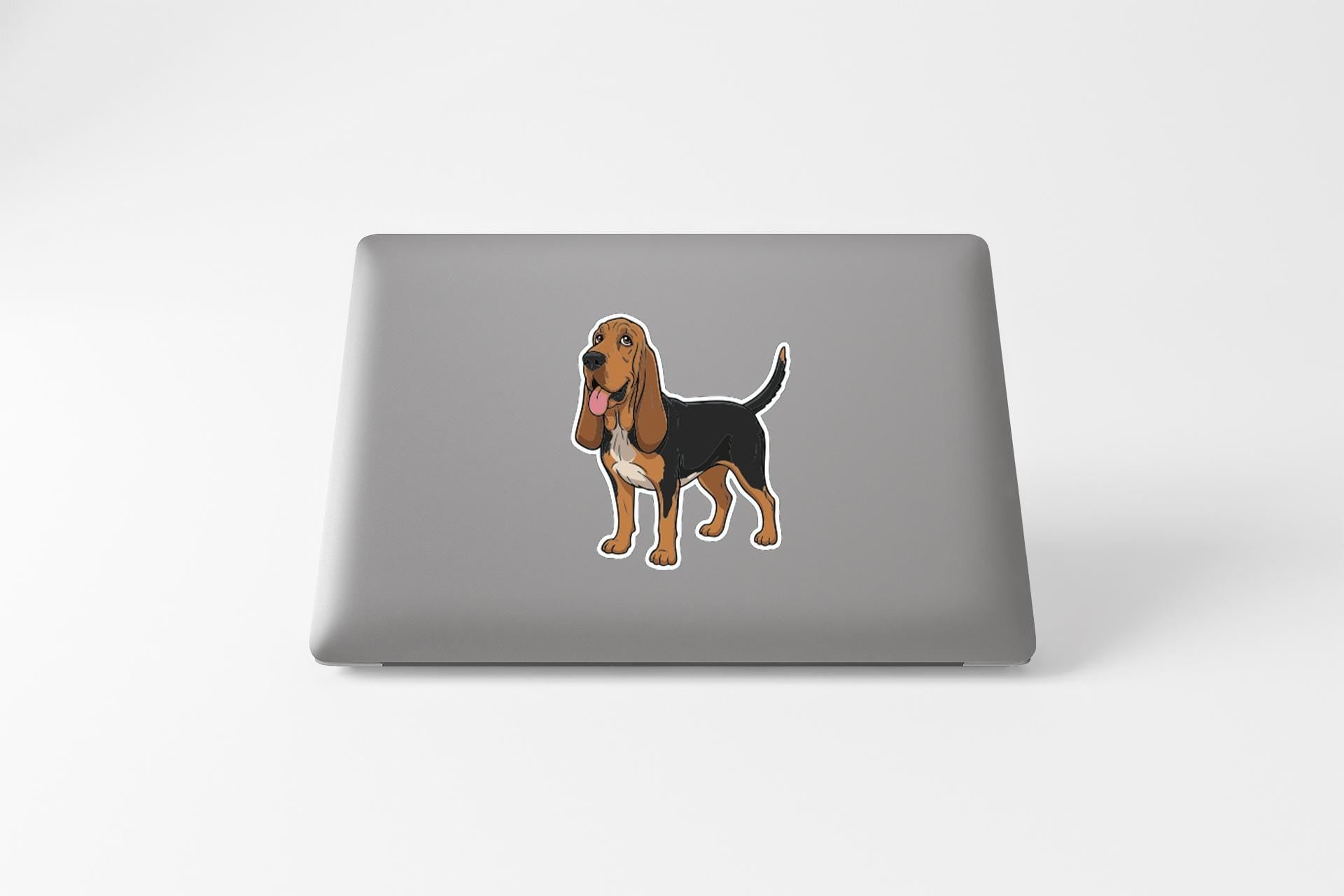 a sticker of a dog on the back of a laptop.
