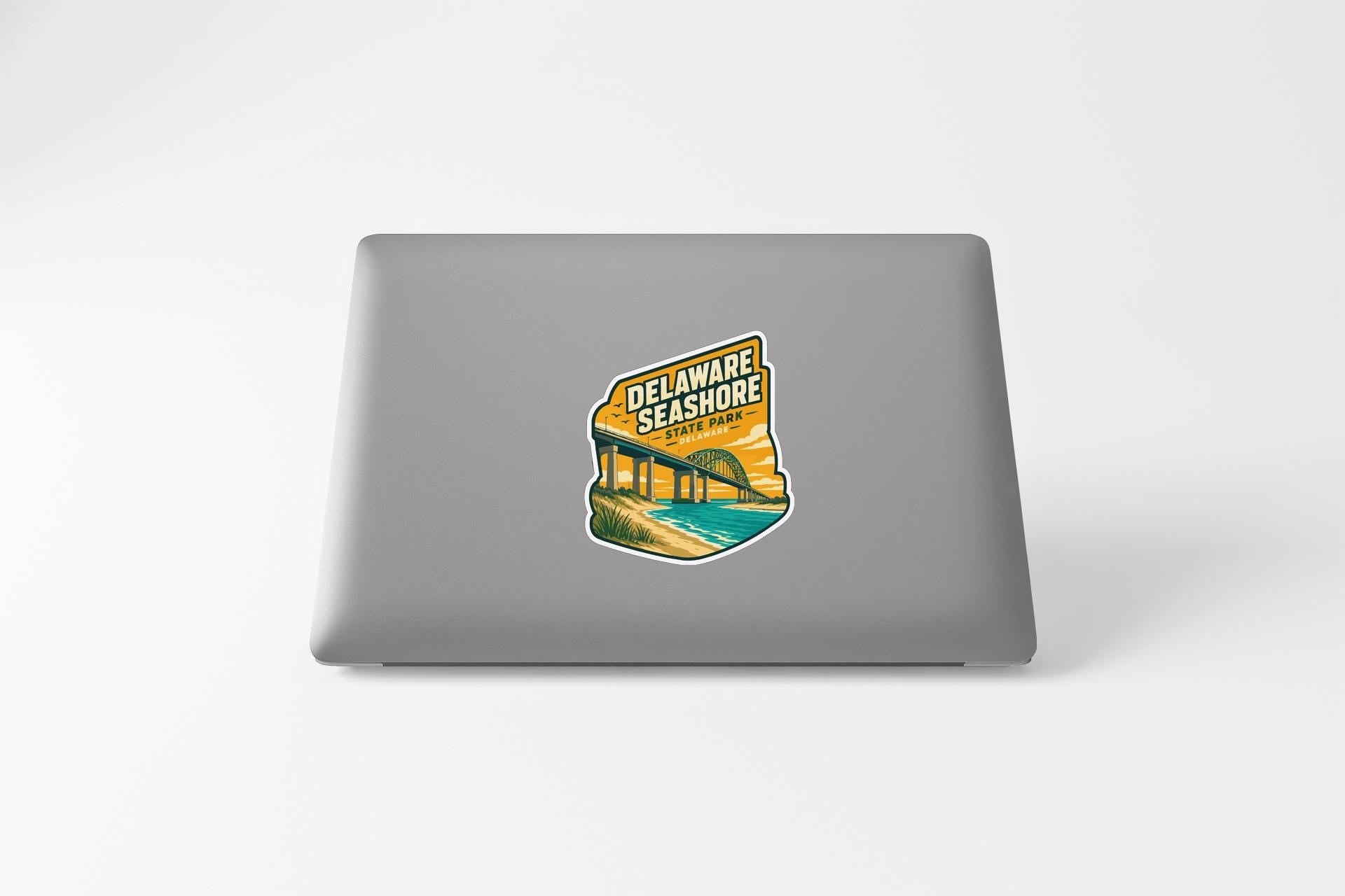 A sticker on the back of a laptop, depicting a scenic view of the Delaware Shore.