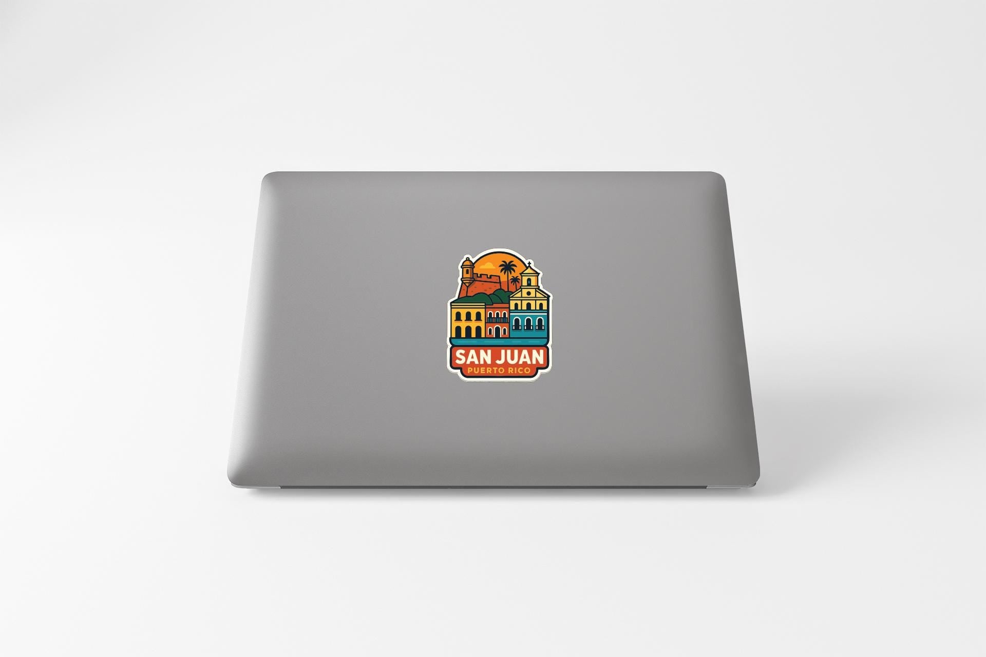 a sticker with a colorful illustration of a building and a palm tree, along with the text "SAN JUAN" and "TO RICO".