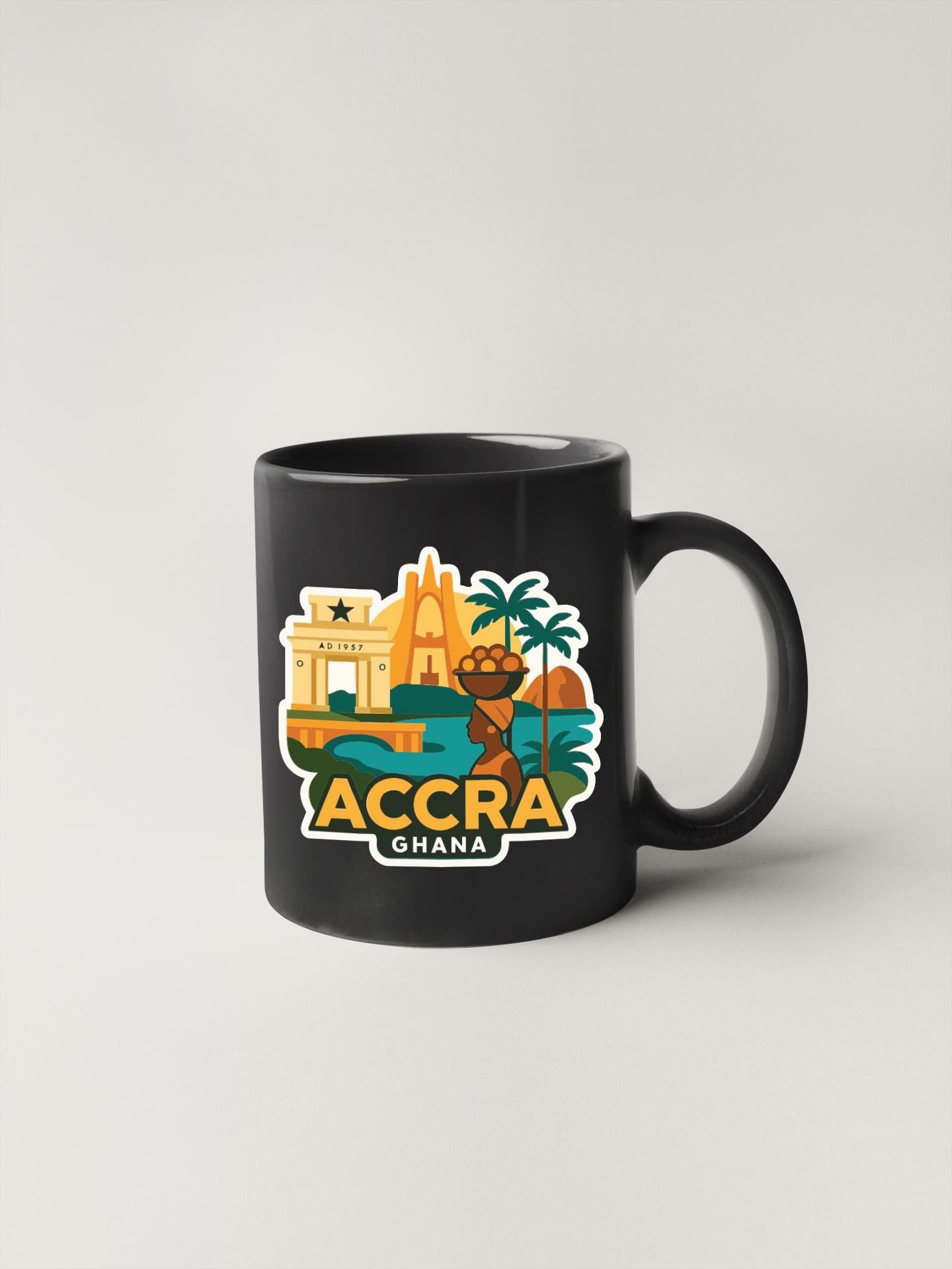 A black coffee mug with a colorful graphic depicting various landmarks and symbols associated with Accra, Ghana.