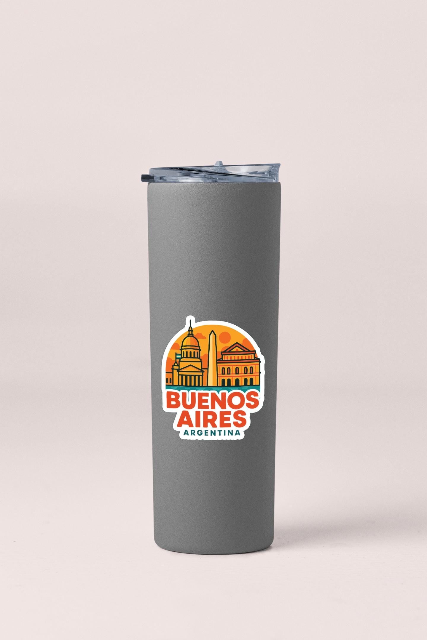 A gray insulated tumbler with a printed design featuring the text "BUENOS AIRES ARGENTINA" and an illustration of the city's skyline.