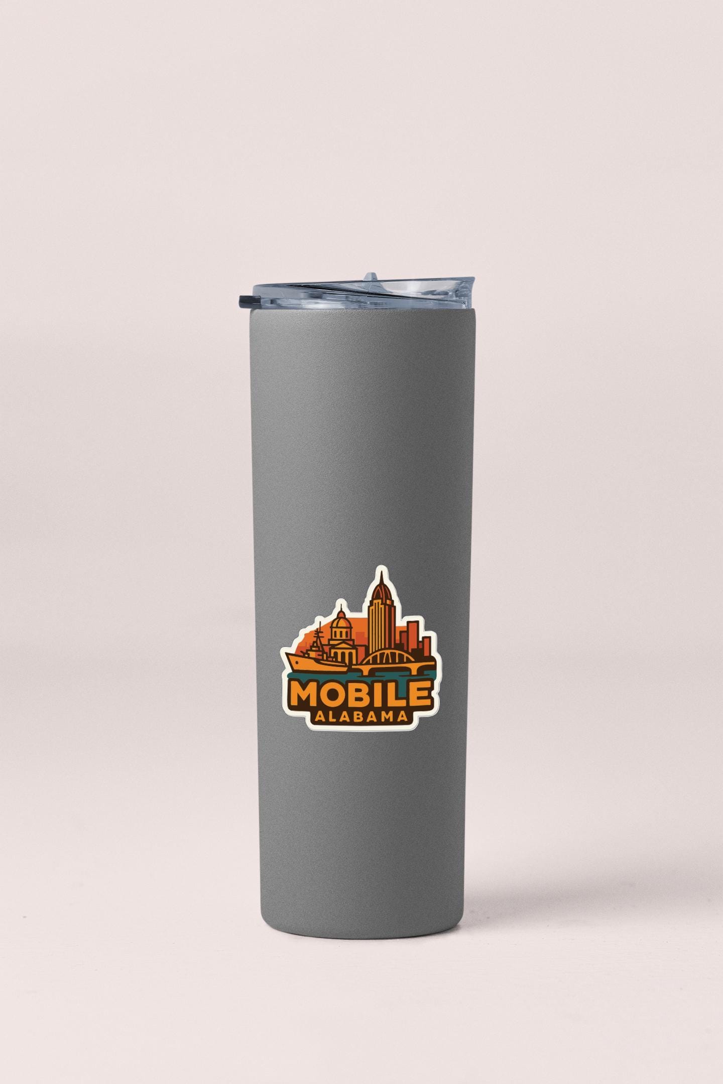 A gray insulated tumbler with a logo on it.