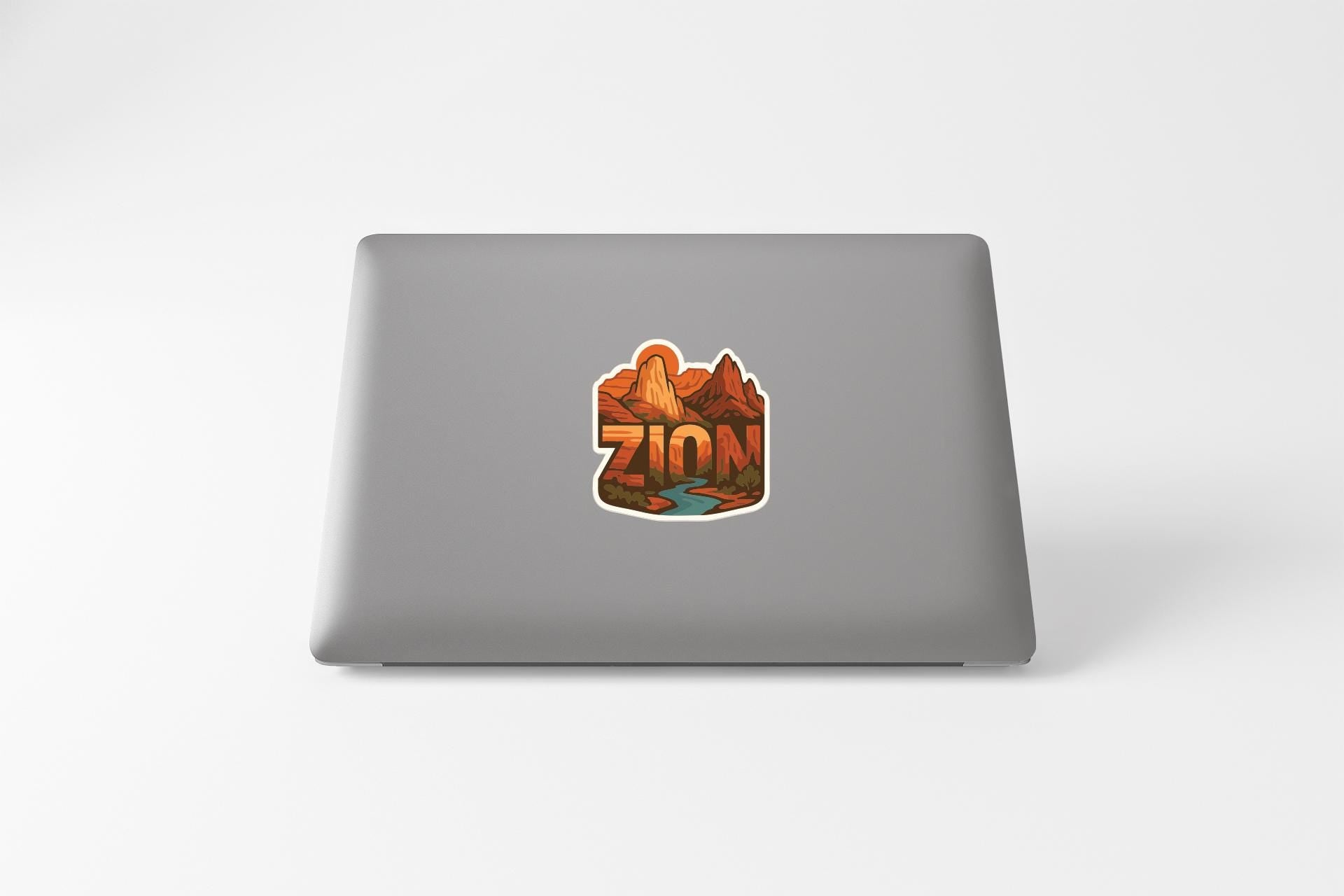 a sticker with the word "ZION" on the back of a laptop.