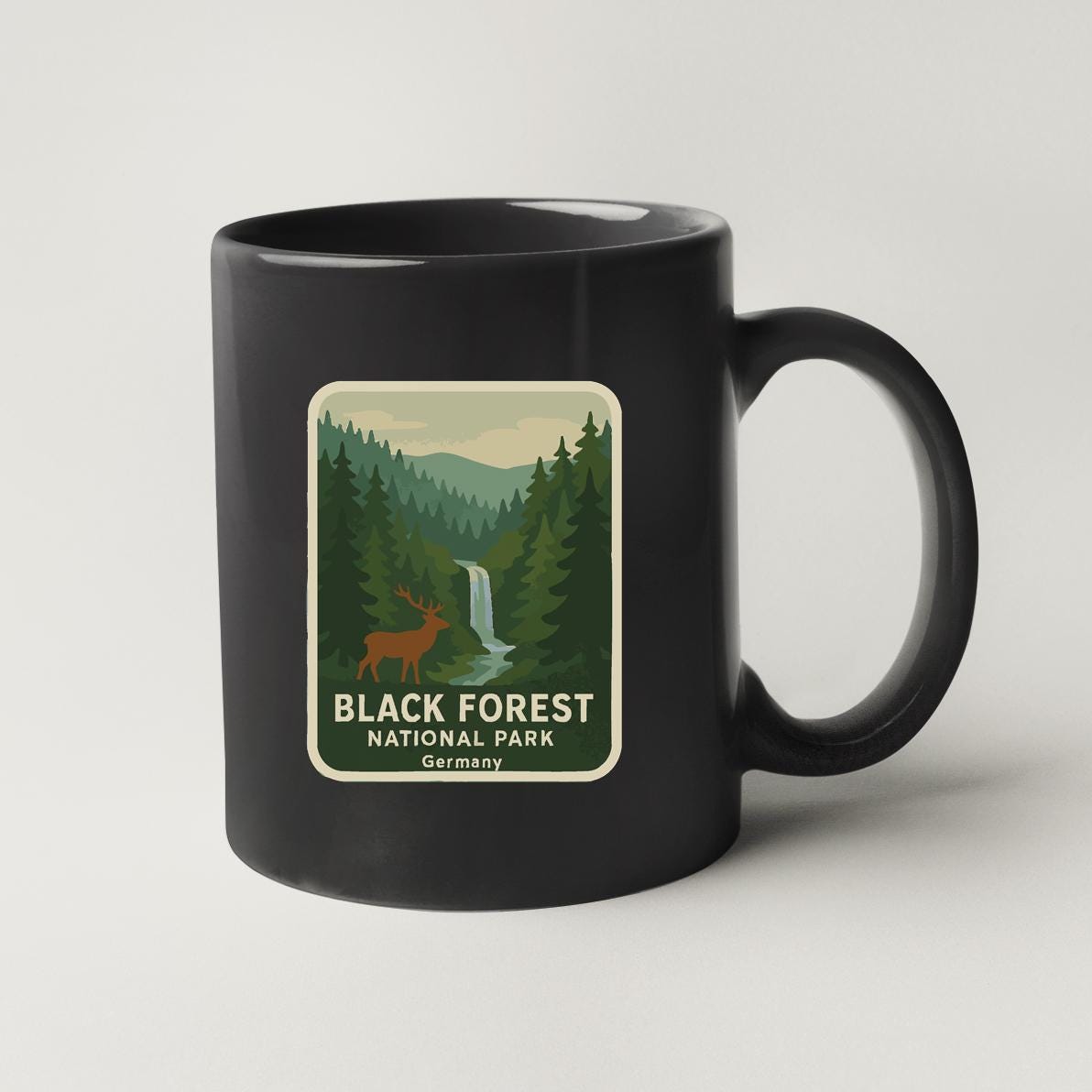 A black coffee mug with a label that says "BLACK FOREST NATIONAL PARK GERMANY".