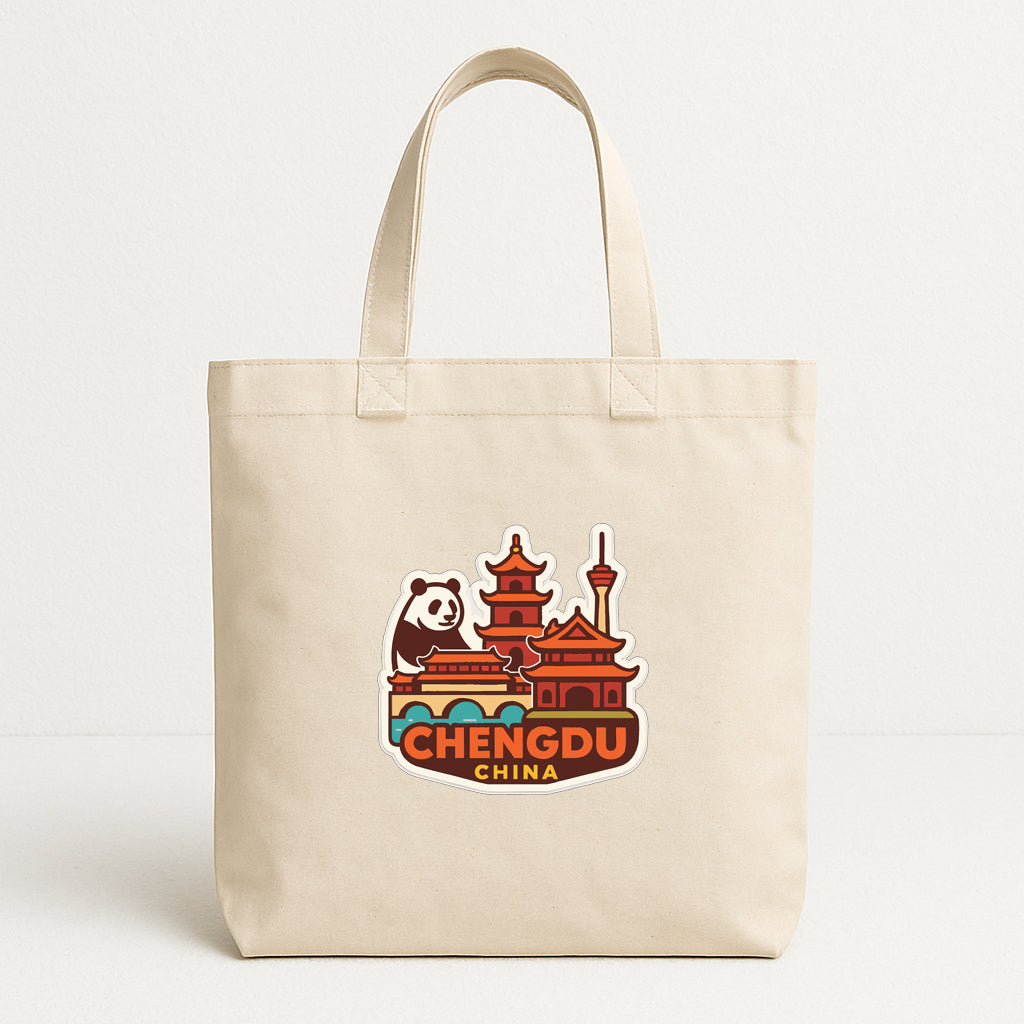 A beige tote bag with a printed design depicting a panda and traditional Chinese architecture, along with the text "CHENG DU CHINA".