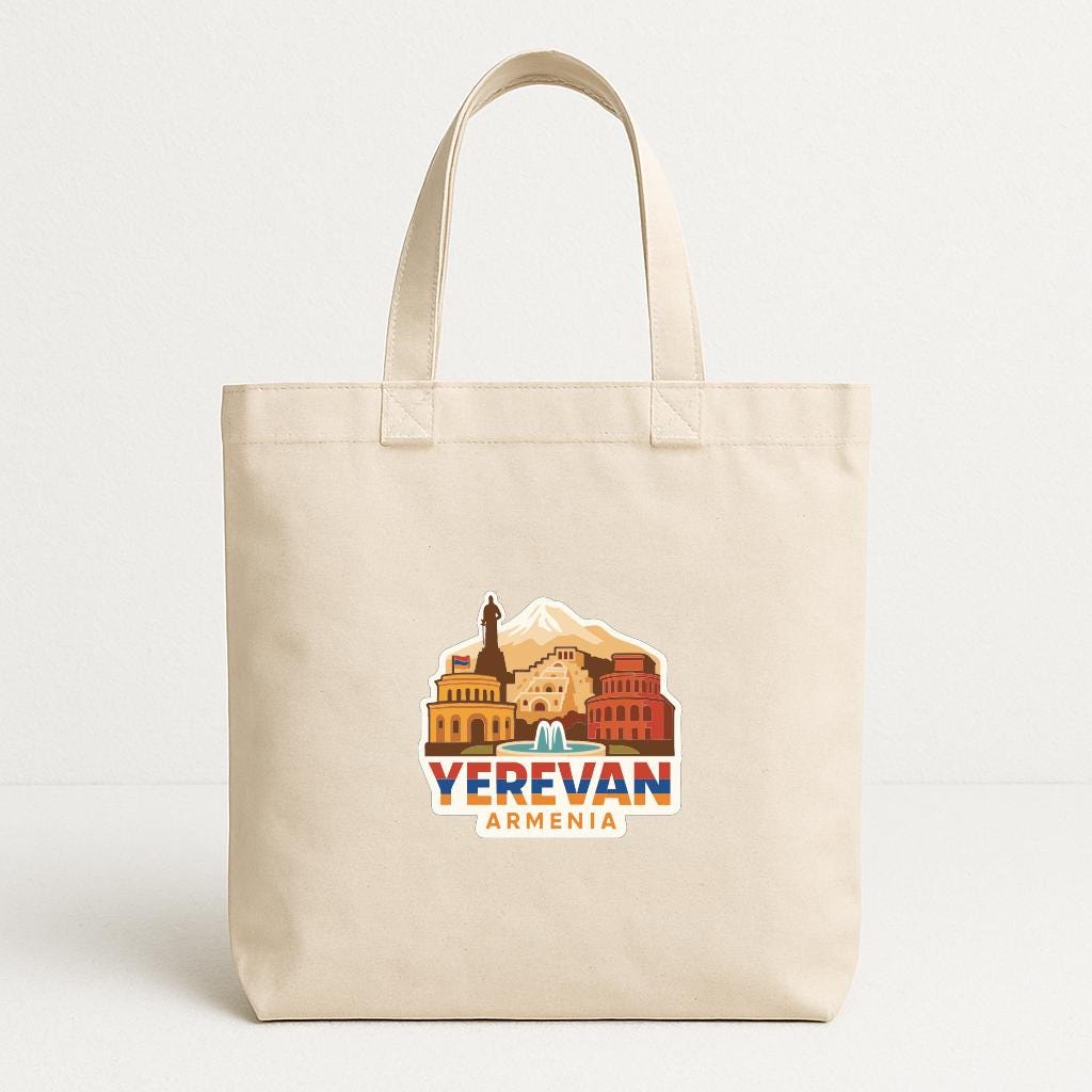 A beige tote bag with a graphic design featuring the text "YEREVAN ARMENIA" and an illustration of a cityscape.