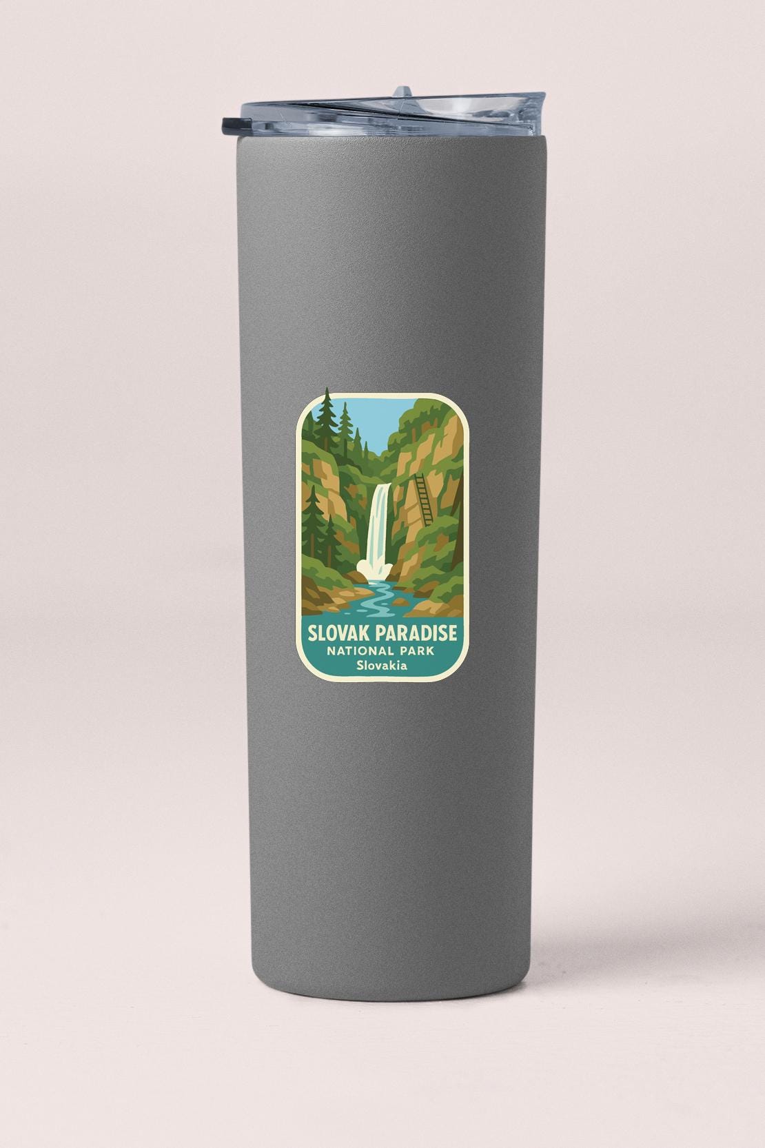 A gray insulated tumbler with a label that features an illustration of a waterfall and the text "SLOVAK PARADISE NATIONAL PARK SOVALIA".