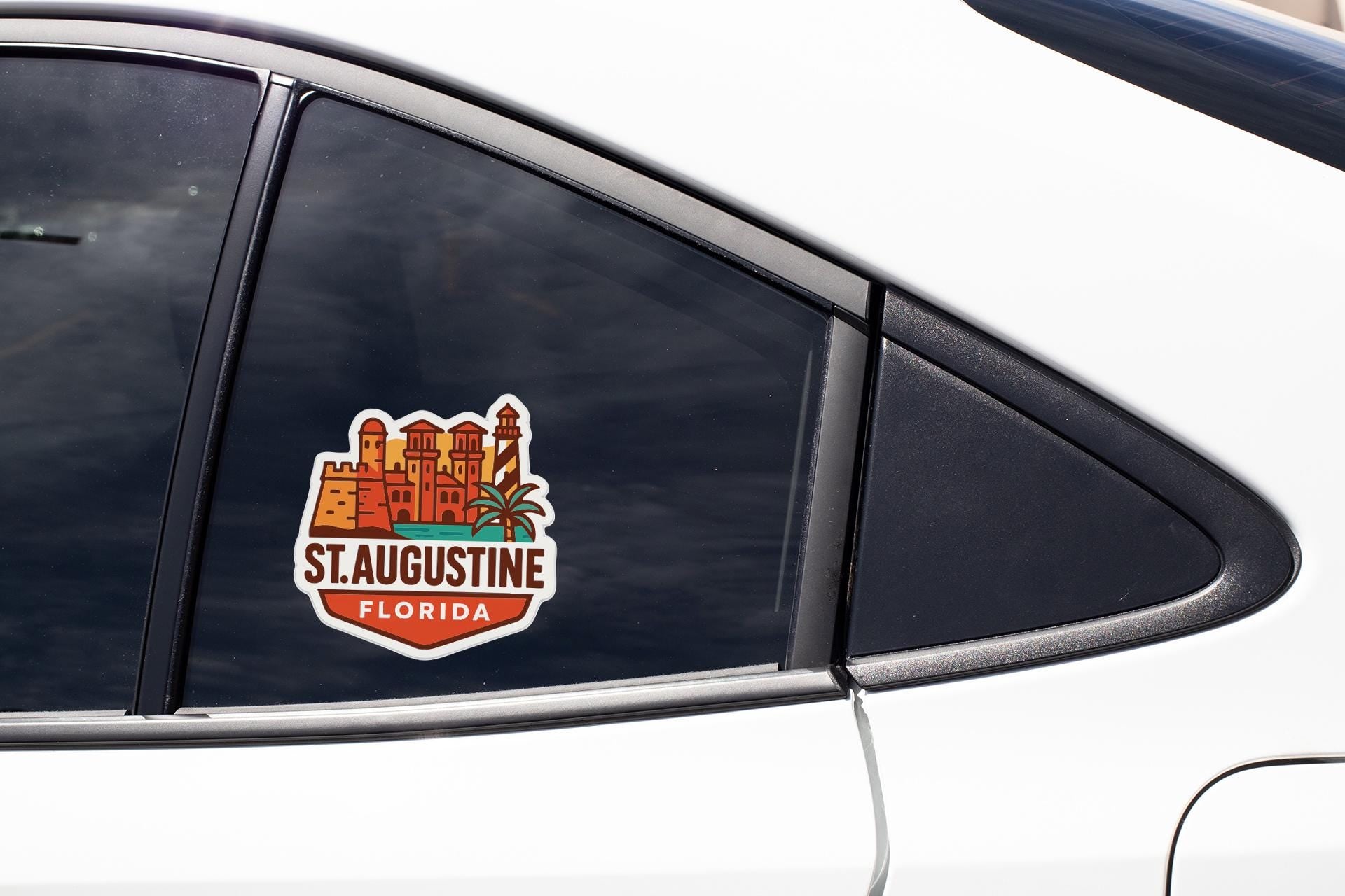 A sticker on the side of a car window that says "St. Augustine, Florida".