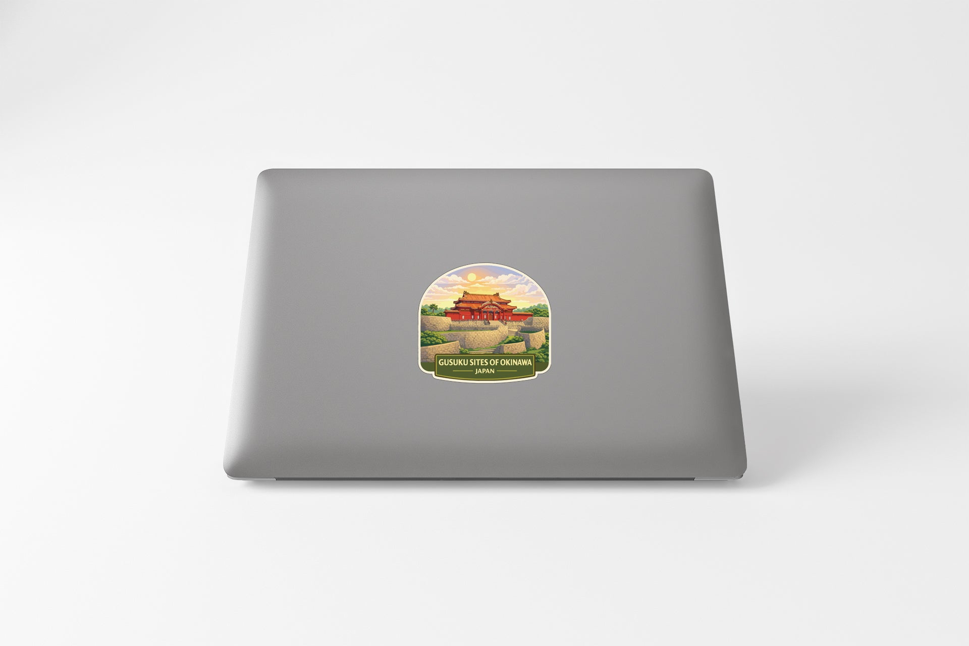 A sticker depicting a traditional Chinese temple or pagoda on a laptop computer.