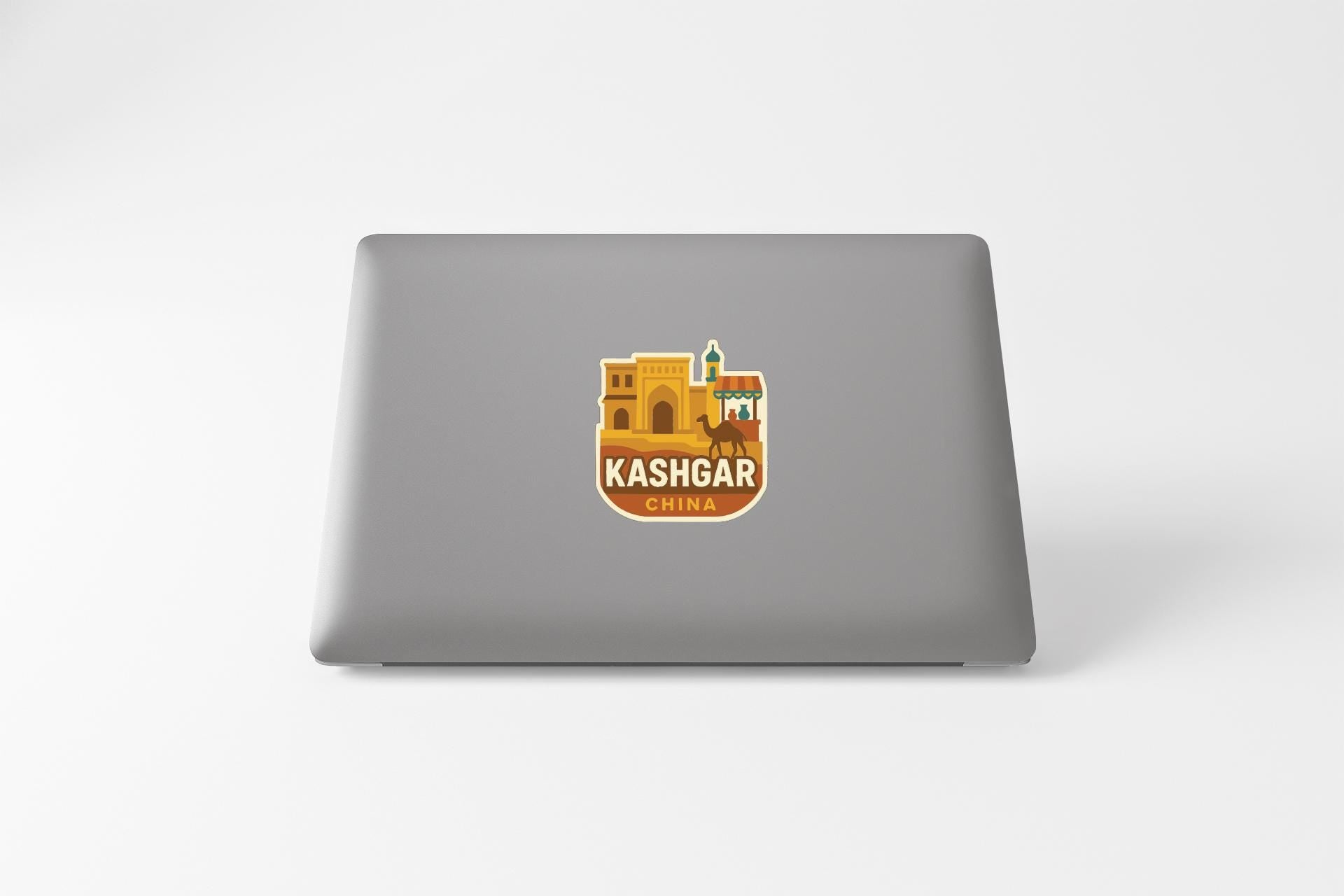 a sticker or logo of the city of Kashgar, China, on the back of a laptop computer.
