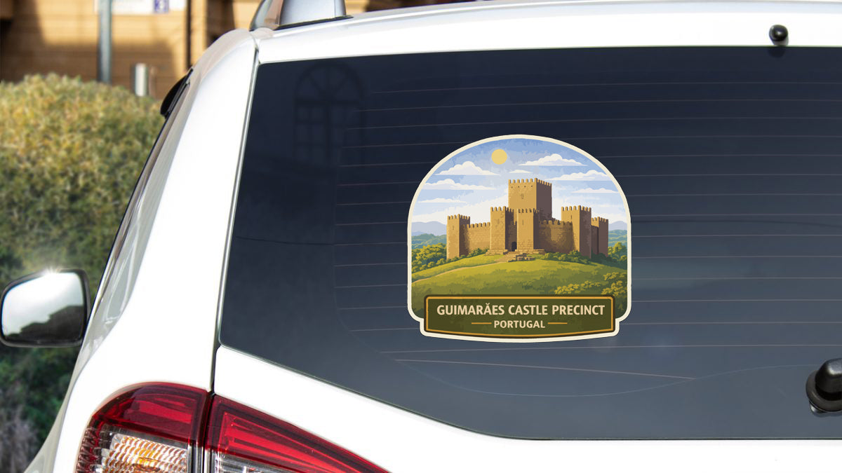 a sticker on the rear window of a car, depicting a castle on a hill.